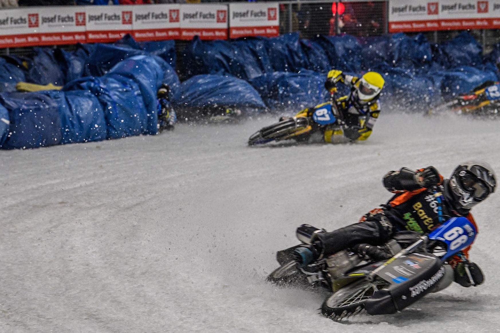 Finland's Aki Ala-Riihimäki (66) (White) leads  as Sweden's Martin Haarahiltunen (199)  (Blue) crashes out during the FIM Ice Speedway Gladiators World Championship Final 2 at the Max-Aicher-Arena, Inzell on Sunday 24 March 2024. (Photo: Ian Charles | MI News)