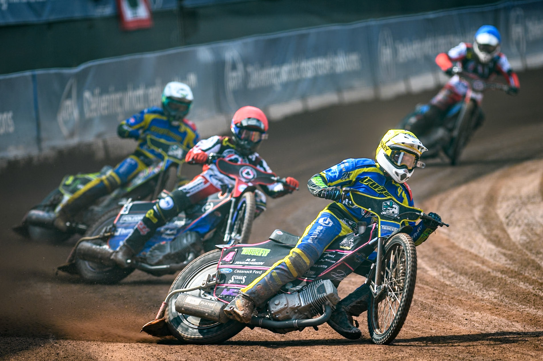 Sheffield Tigers' Josh Pickering  in Yellow leading Belle Vue Aces' Brady Kurtz  in Red and Sheffield Tigers' Chris Holder  in White with Belle Vue Aces' Antti Vuolas  in Blue behind during the Rowe Motor Oil Premiership match between Belle Vue Aces and Sheffield Tigers at the National Speedway Stadium, Manchester on Monday 26th August 2024. (Photo: Ian Charles | MI News)