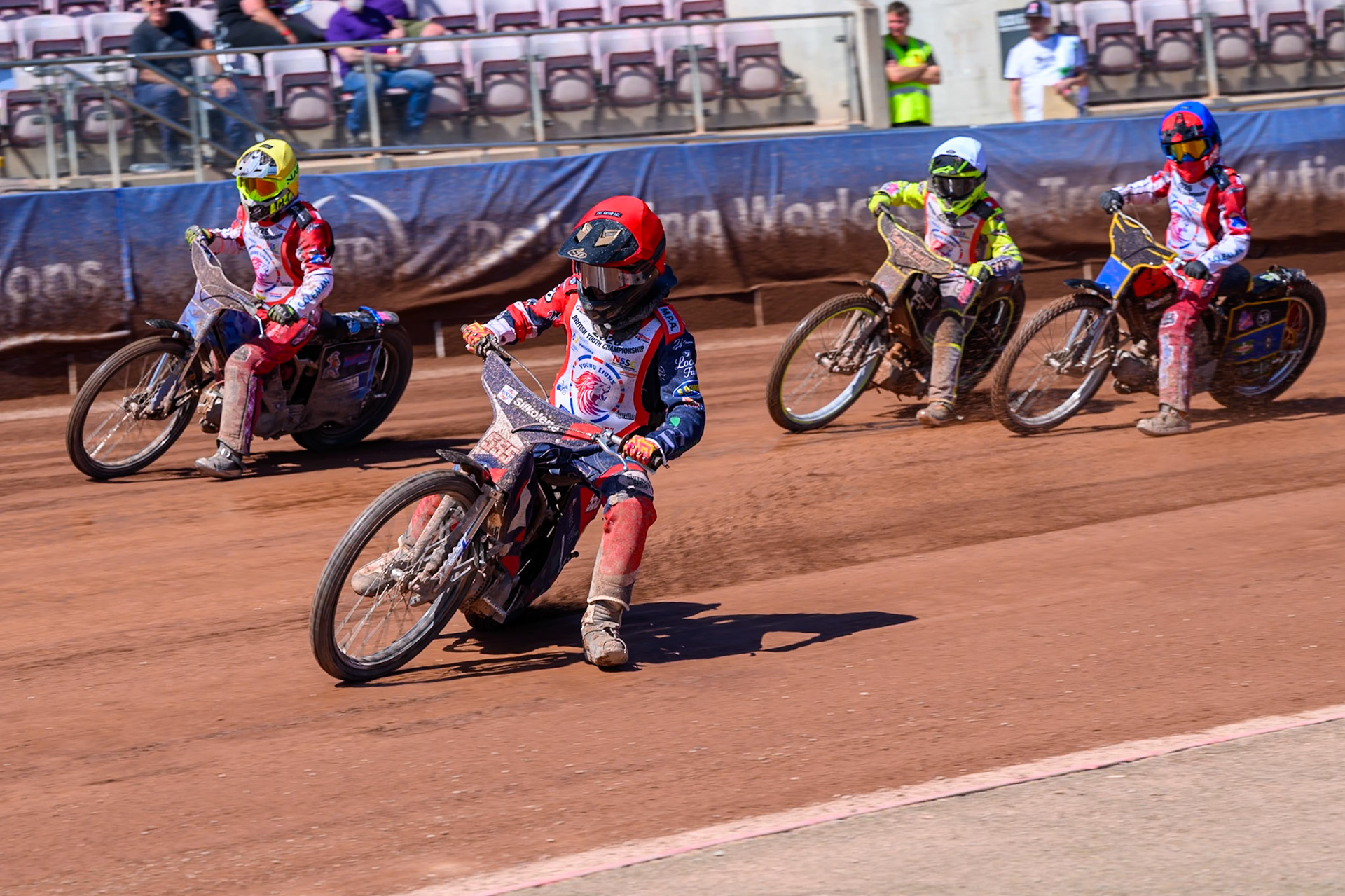 BRITISH YOUTH CHAMPIONSHIP 125cc Fraser Buckle (555) in Red leading Ella Marshall (12)  in Yellow George Climo (83) in White  and Douglas Marshall (99) in Blue during the British Youth Championship (125cc) at the National Speedway Stadium, Manchester on Sunday 19th July 2026. (Photo: Ian Charles | MI News)