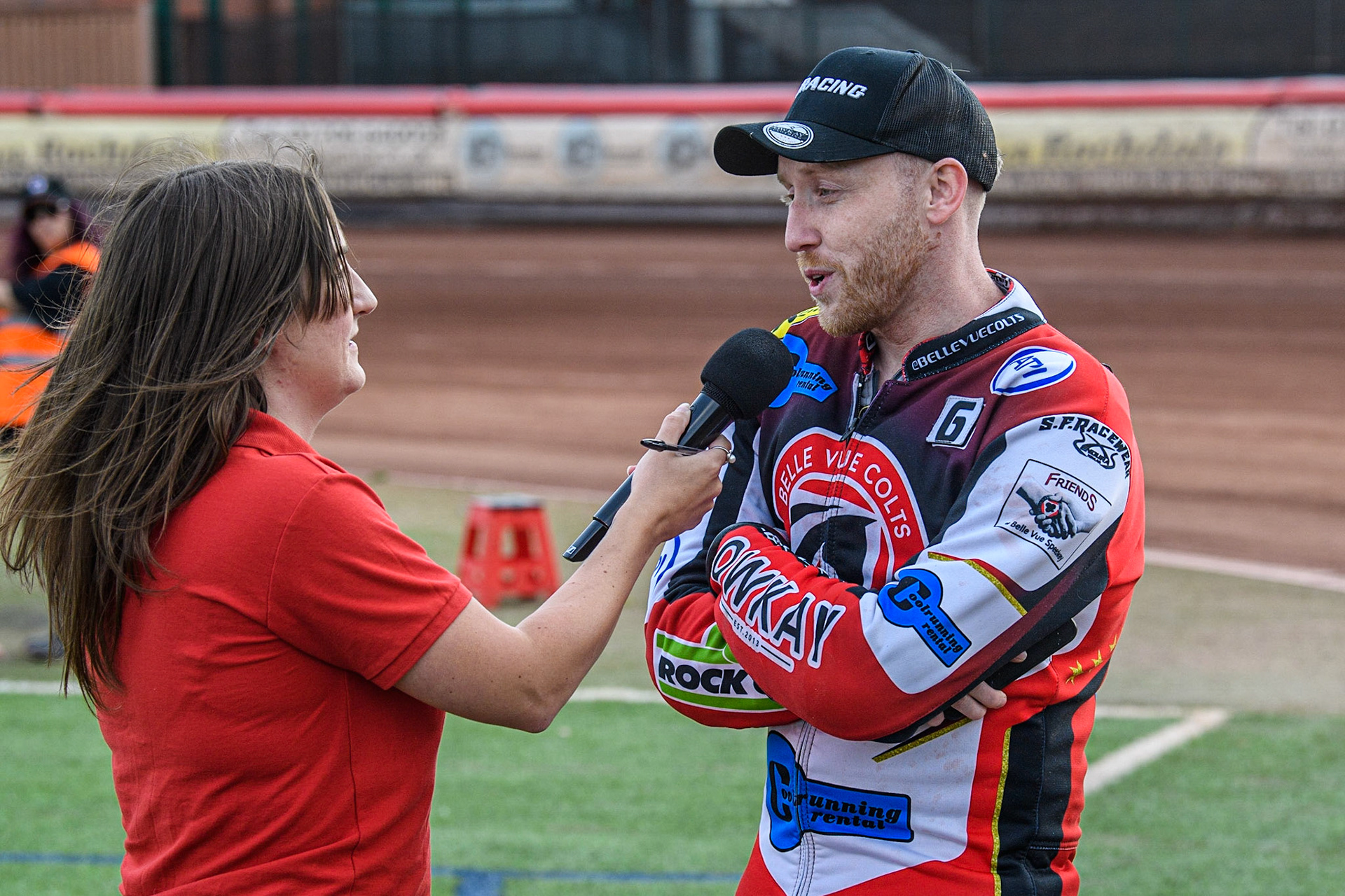 Paul Bowen (Red) gives an interview to Meeting presenter Hayley Bromley about the New Electric Speedway Bike during the British Youth Speedway Championships at the National Speedway Stadium, Manchester on Friday 21st July 2023. (Photo: Ian Charles | MI News)