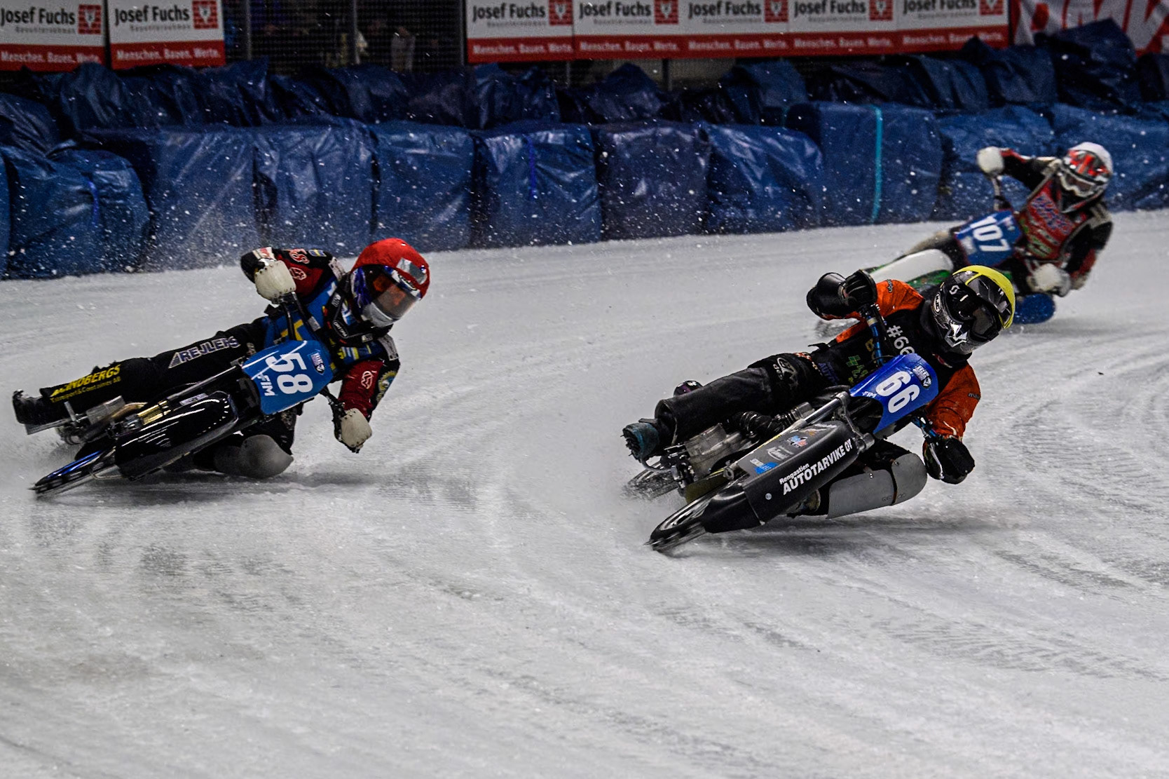 Finland's Aki Ala-Riihimäki (66) (Blue) inside Sweden's Stefan Svensson (58) (Red) with Czech Republic's Andrej Diviš (107) (White) behind during the FIM Ice Speedway Gladiators World Championship Final 1 at the Max-Aicher-Arena, Inzell on Saturday 23 March 2024. (Photo: Ian Charles | MI News)