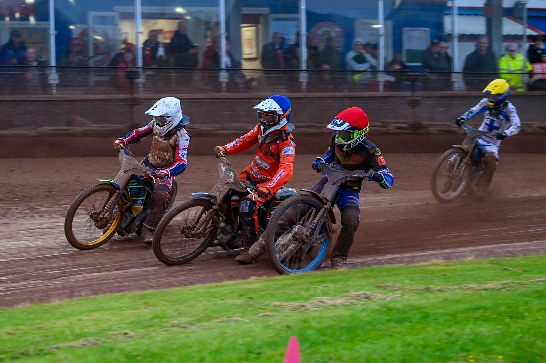 Mario Hausl of Germany in Red rides inside Sven Cerjak of Slovenia in Blue and Lasse Fredriksen of Norway in White with Antti Vuolas of Finland in Yellow behind during the Speedway GP Qualifying Round 3 at Allied Ashfield Stadium, Glasgow on Saturday 30th May 2026. (Photo: Ian Charles | MI News)