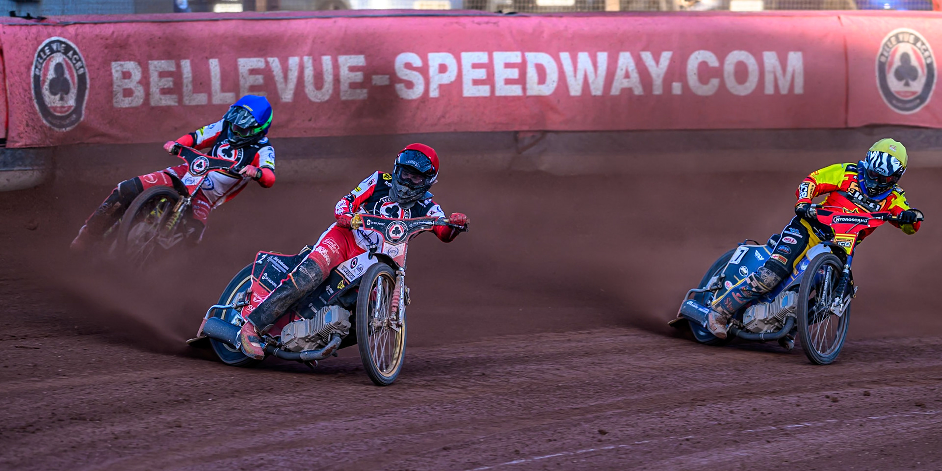 Belle Vue Aces' Norick Blödorn in Red leading Leicester Lions' Joe Thompson  in Yellow and Belle Vue Aces' Will Cairns in Blue during the Rowe Motor Oil Premiership match between Belle Vue Aces and Leicester Lions at the National Speedway Stadium, Manchester on Monday 14th July 2025. (Photo: Ian Charles | MI News)