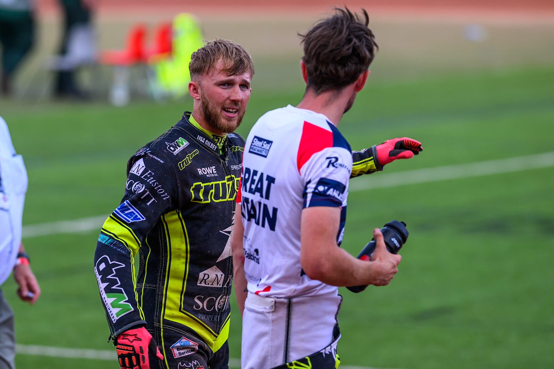 Ipswich Witches' Jordan Jenkins (Left) walks back to the pits with Ipswich Witches' Adam Ellis  after Jenkins fell in heat 8 during the Rowe Motor Oil Premiership match between Belle Vue Aces and Ipswich Witches at the National Speedway Stadium, Manchester on Monday 30th June 2025. (Photo: Ian Charles | MI News)