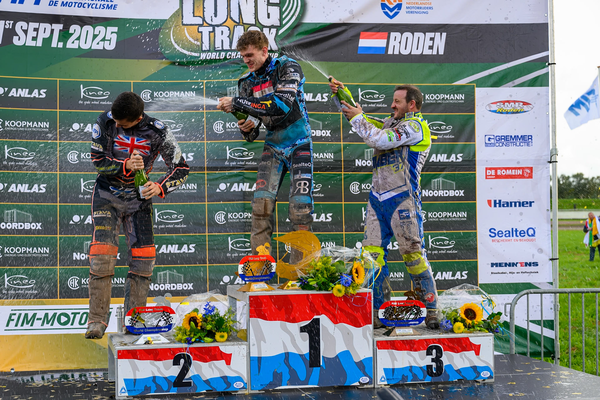 Champagne capers after the Meeting final (L to R) Zach Wajtknecht (109) of Great Britain (2nd), Dave Meijerink (63) of The Netherlands (winner) and Chris Harris (37) of Great Britain (3rd) during the FIM Long Track World Championship Final 4, at the Speed Centre Roden, Netherlands on Sunday 21st September 2025. (Photo: Ian Charles | MI News)during the FIM Long Track World Championship Final 4, at the Speed Centre, Roden on Sunday 21st September 2025. (Photo: Ian Charles | MI News)