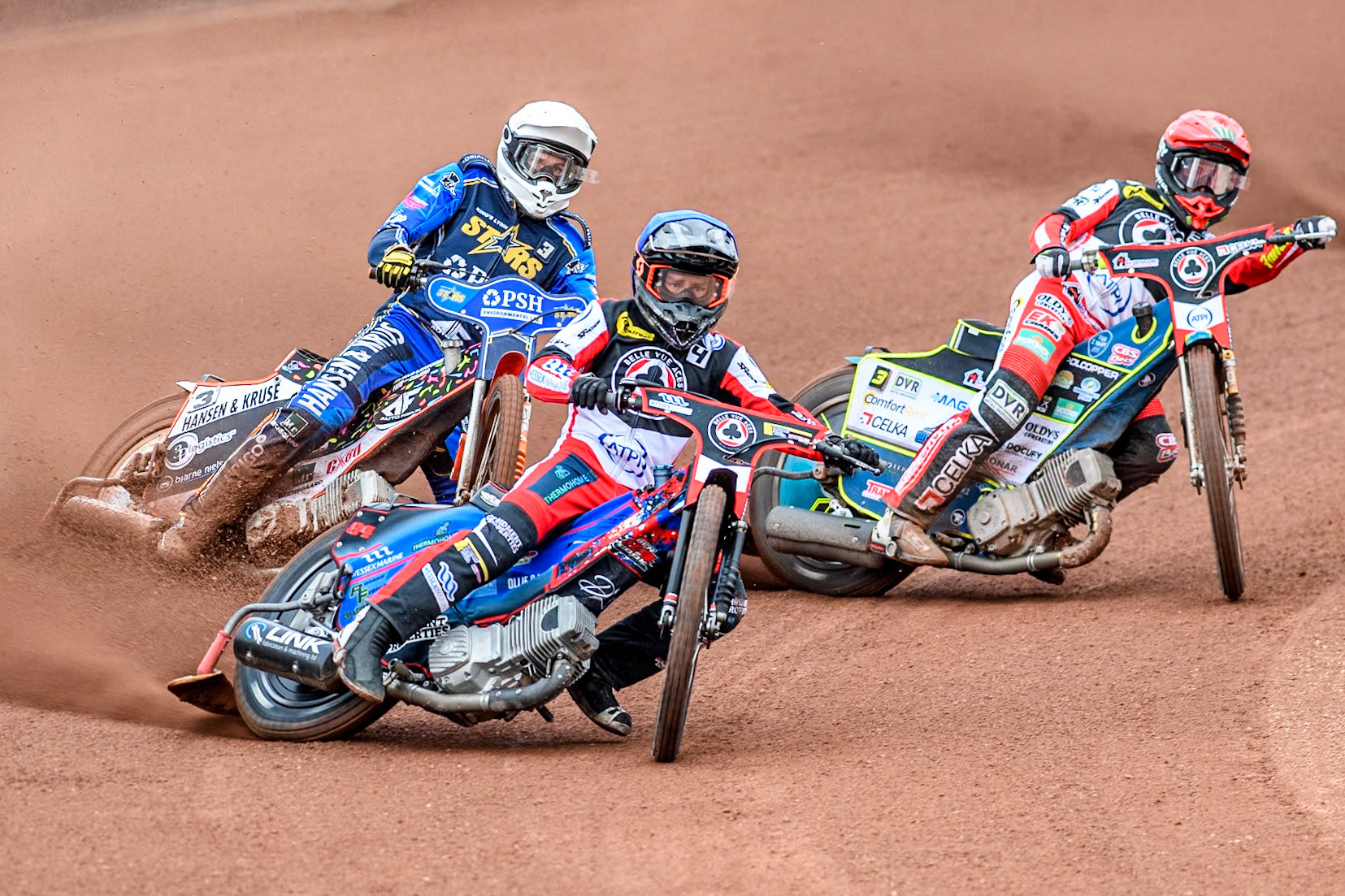 Belle Vue Aces' Ben Cook in Blue and Belle Vue Aces' Jaimon Lidsey in Red leading King Lynn Stars' Niels-Kristian Iversen in White during the Rowe Motor Oil Premiership match between Belle Vue Aces and King's Lynn Stars at the National Speedway Stadium, Manchester on Monday 20th May 2024. (Photo: Ian Charles | MI News)