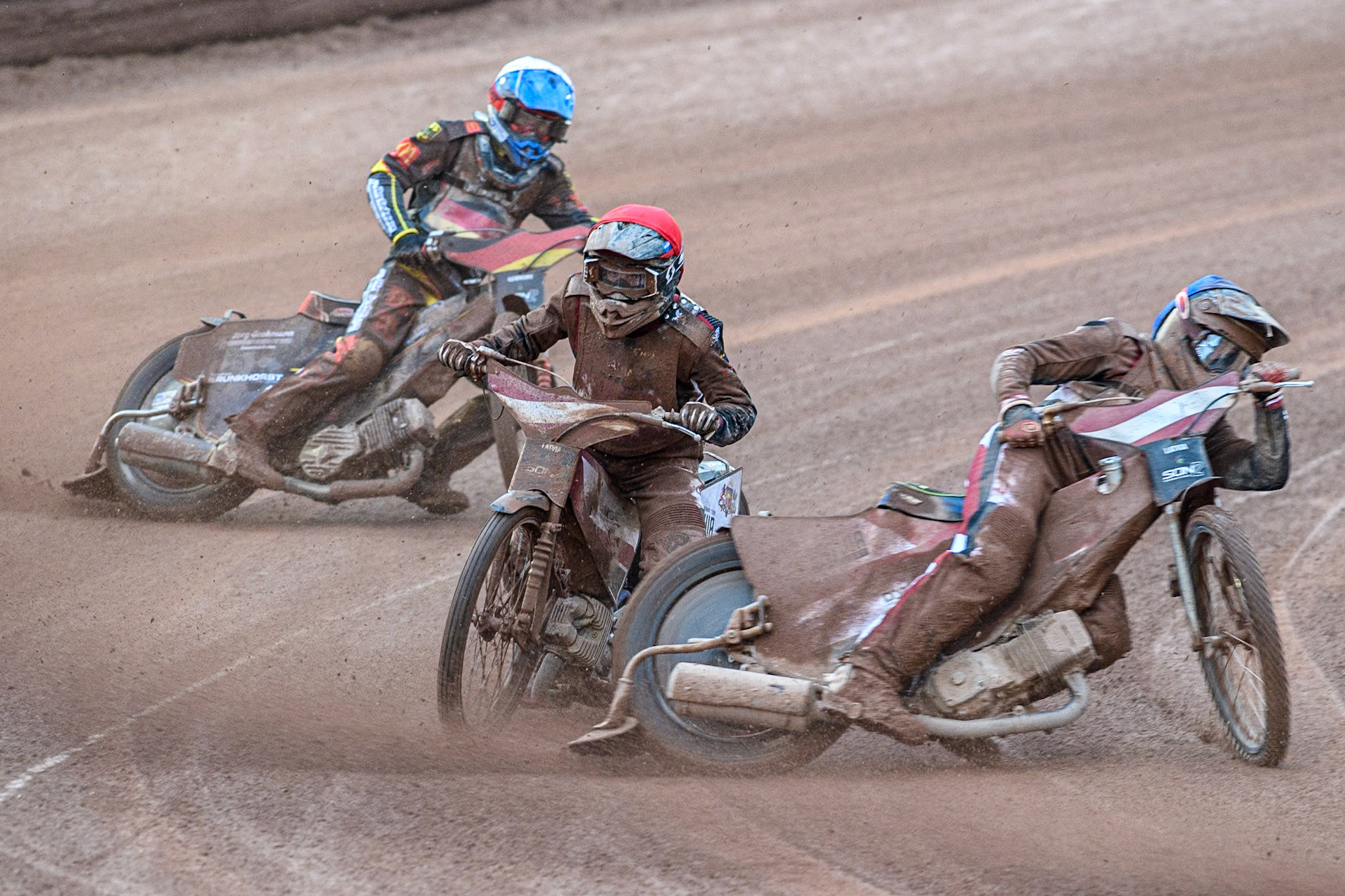 Norick Blödorn of Germany in Yellow leading Nikita Kaulins of Latvia in Blue as Artjoms Juhno of Latvia in Red picks up some drive ahead of Patrick Hyjek of Germany in White during the Monster Energy FIM Speedway of Nations 2 (Under 21) Final at the National Speedway Stadium, Manchester on Friday 12th July 2024. (Photo: Ian Charles | MI News)