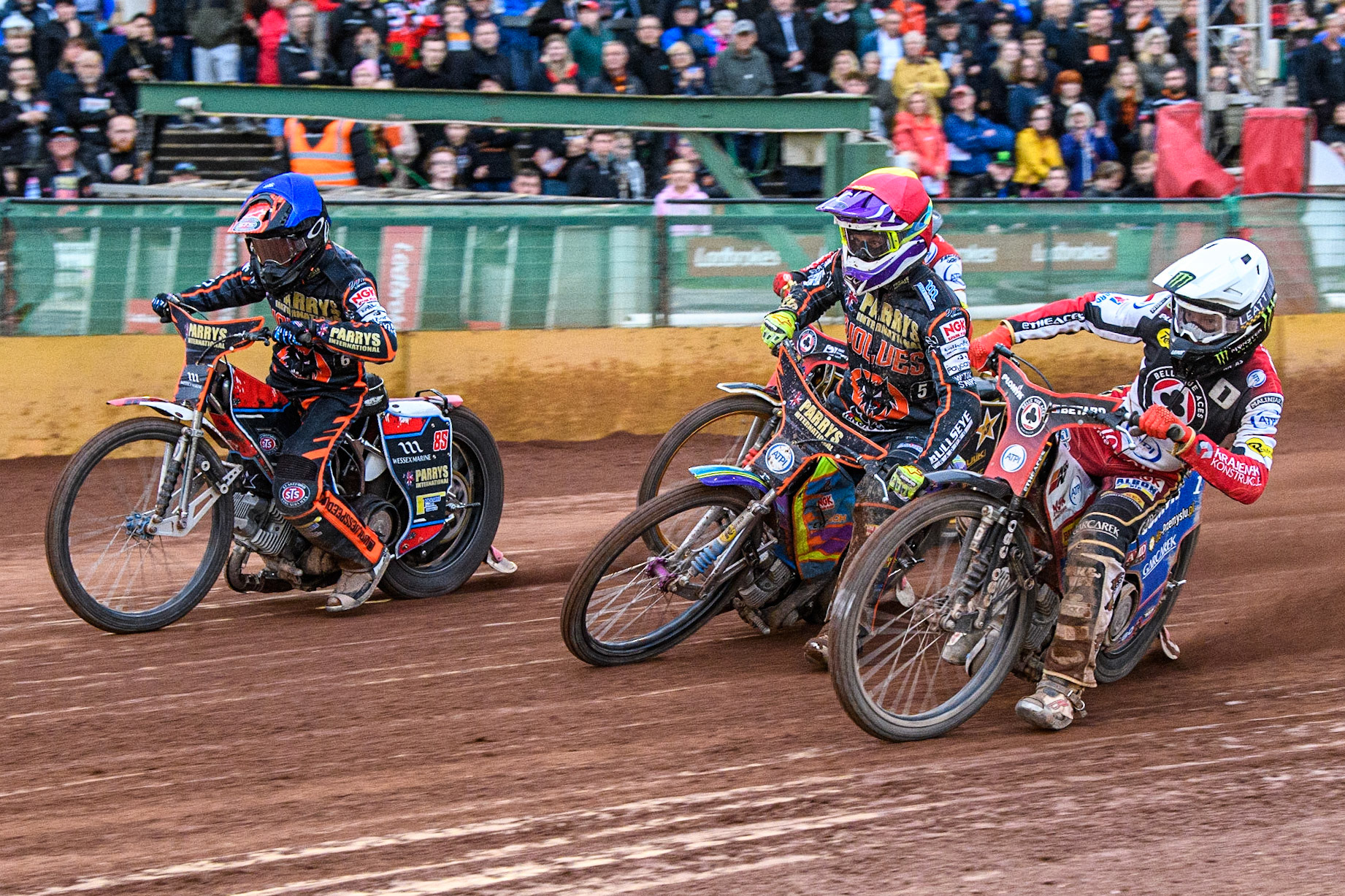 Dan Bewley (White) inside Rory Schlein (Red) and Zach Cook (Blue) during the Sports Insure Premiership match between Wolverhampton Wolves and Belle Vue Aces at Monmore Green Stadium, Wolverhampton on Monday 10th July 2023. (Photo: Ian Charles | MI News)