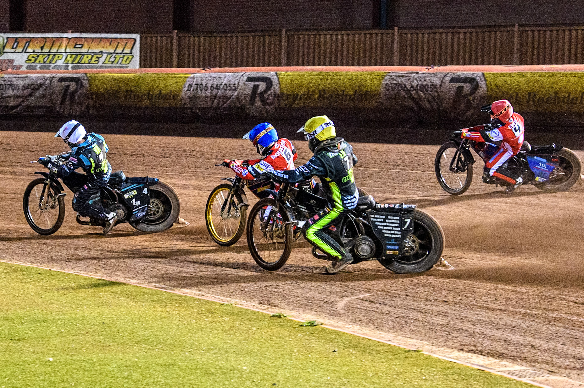 Ipswich Witches' Dan Thompson in Yellow chases Belle Vue Aces' Ben Cook in Red, Belle Vue Aces' Connor Mountain in Blue and Ipswich Witches' Guest Ryan Douglas in White during the Rowe Motor Oil Premiership match between Belle Vue Aces and Ipswich Witches at the National Speedway Stadium, Manchester on Monday 22nd April 2024. (Photo: Ian Charles | MI News)