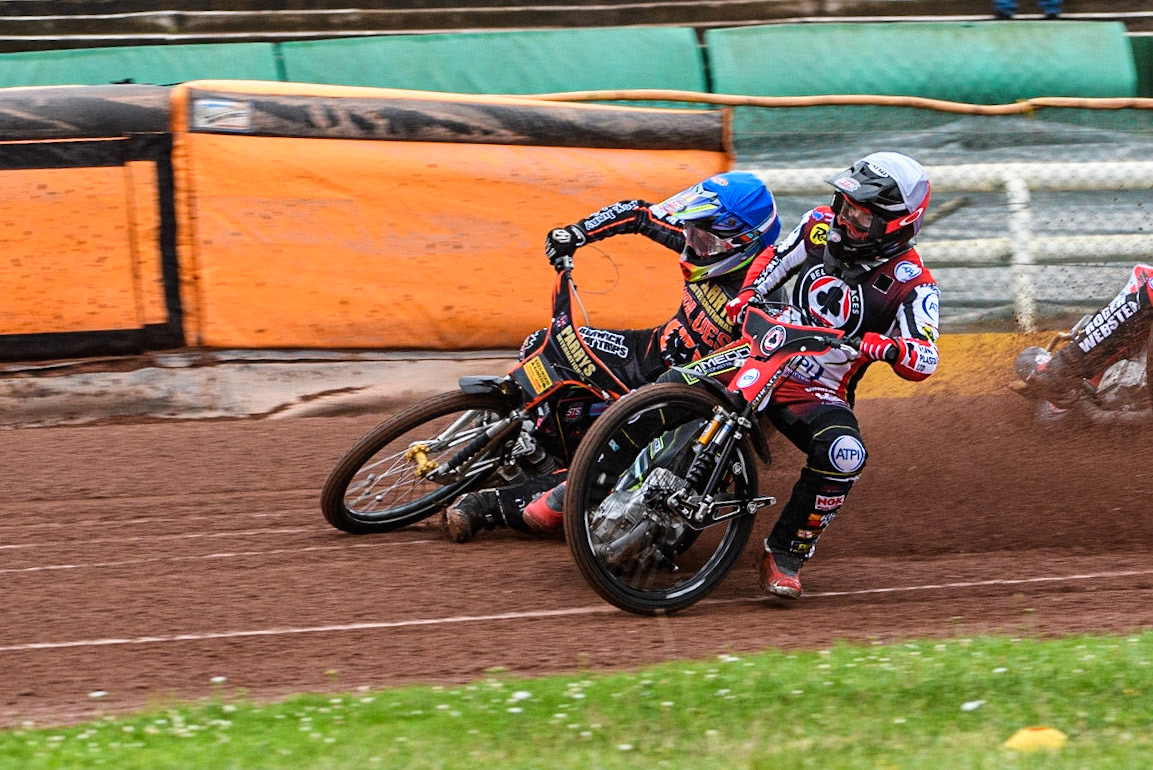 Tom Brennan (White) inside Leon Flint (Blue) as he falls in the first bend during the Sports Insure Premiership match between Wolverhampton Wolves and Belle Vue Aces at Monmore Green Stadium, Wolverhampton on Monday 10th July 2023. (Photo: Ian Charles | MI News)