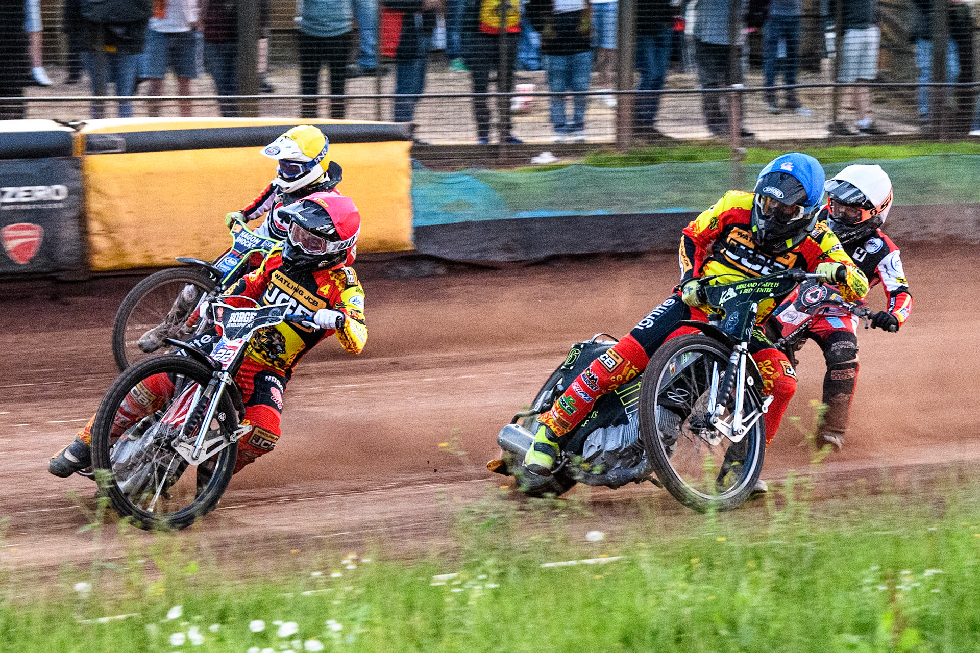 Leicester Lions' Luke Becker in Red leading Leicester Lions' Craig Cook in Blue with Leicester Lions' Sam Hagon in Yellow on the outside and Belle Vue Aces' Ben Cook in White at the back during the Rowe Motor Oil Premiership match between Leicester Lions and Belle Vue Aces at the Pidcock Motorcycles Arena, Leicester on Thursday 25th July 2024. (Photo: Ian Charles | MI News)