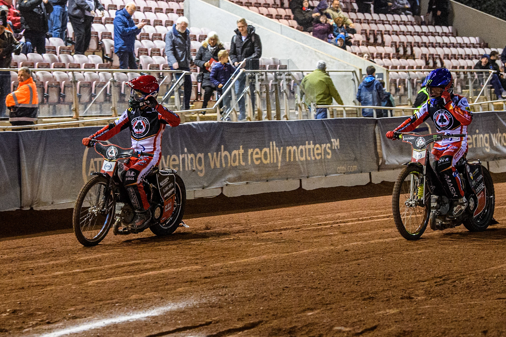 Belle Vue Aces' Brady Kurtz in Red and Belle Vue Aces' Jaimon Lidsey in Blue wave to the fans after their win in Heat 15 during the Rowe Motor Oil Premiership match between Belle Vue Aces and Oxford Spires at the National Speedway Stadium, Manchester on Monday 14th April 2025. (Photo: Ian Charles | MI News)