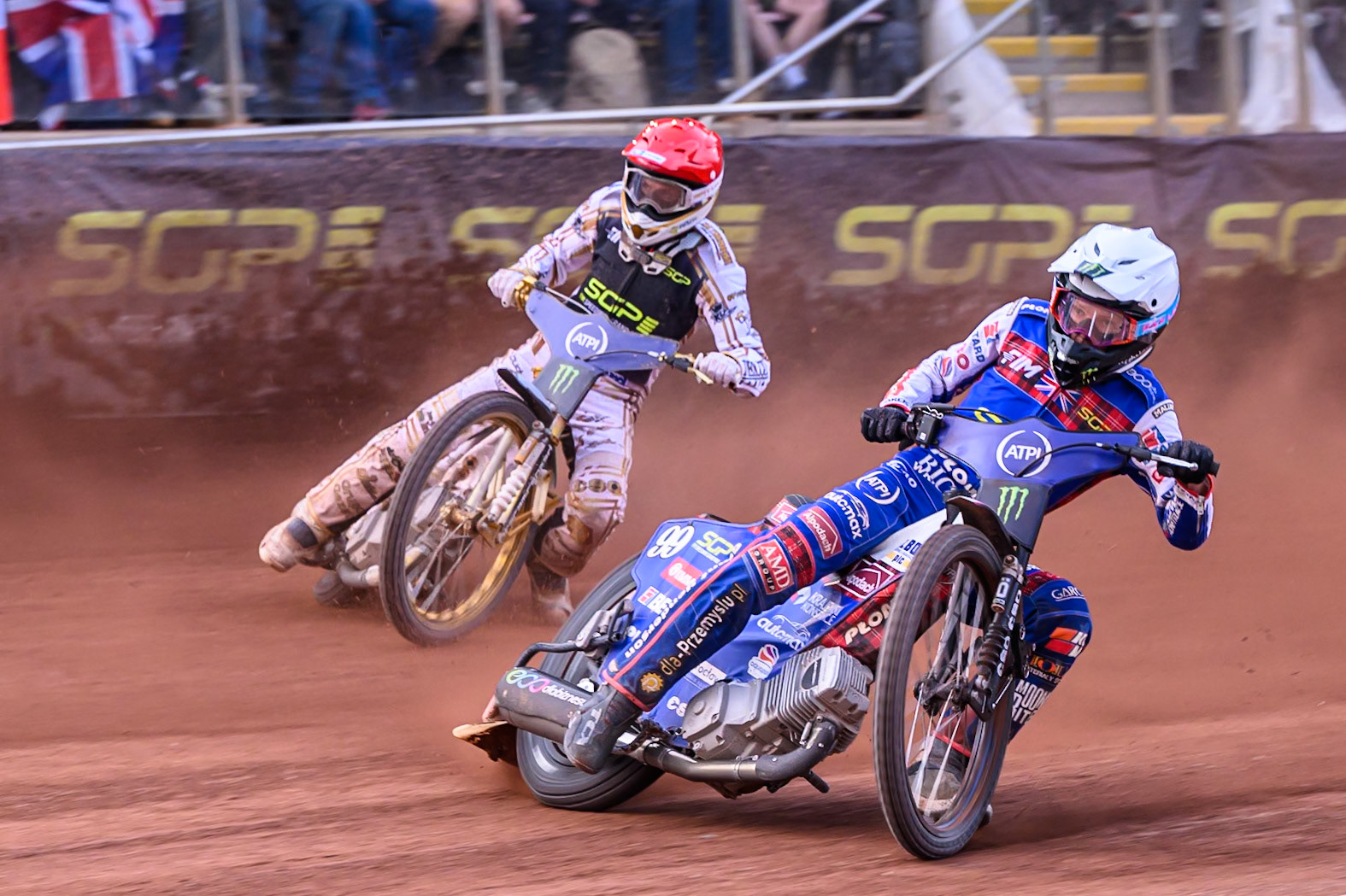 Dan Bewley (99) of Great Britain in White passes Anders Thomsen (105) of Denmark in Red during the ATPI FIM Speedway Grand Prix Round 4 at the National Speedway Stadium, Manchester, on Friday 13th June 2025. (Photo: Ian Charles | MI News)