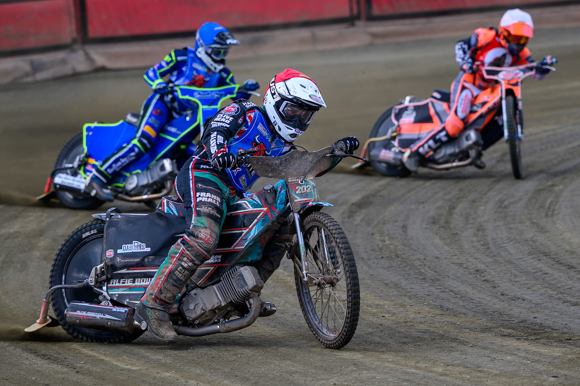 Alfie Bowtell of Buxton Bulls in Red leading Arran Butcher of Buxton Bulls in Blue and Connor Coles of NDL Nomads   in White during the  Challenge match between Buxton Bulls and NDL Nomads at Hi-Edge Speedway, Buxton on Sunday 19th April 2026. (Photo: Ian Charles | MI News)