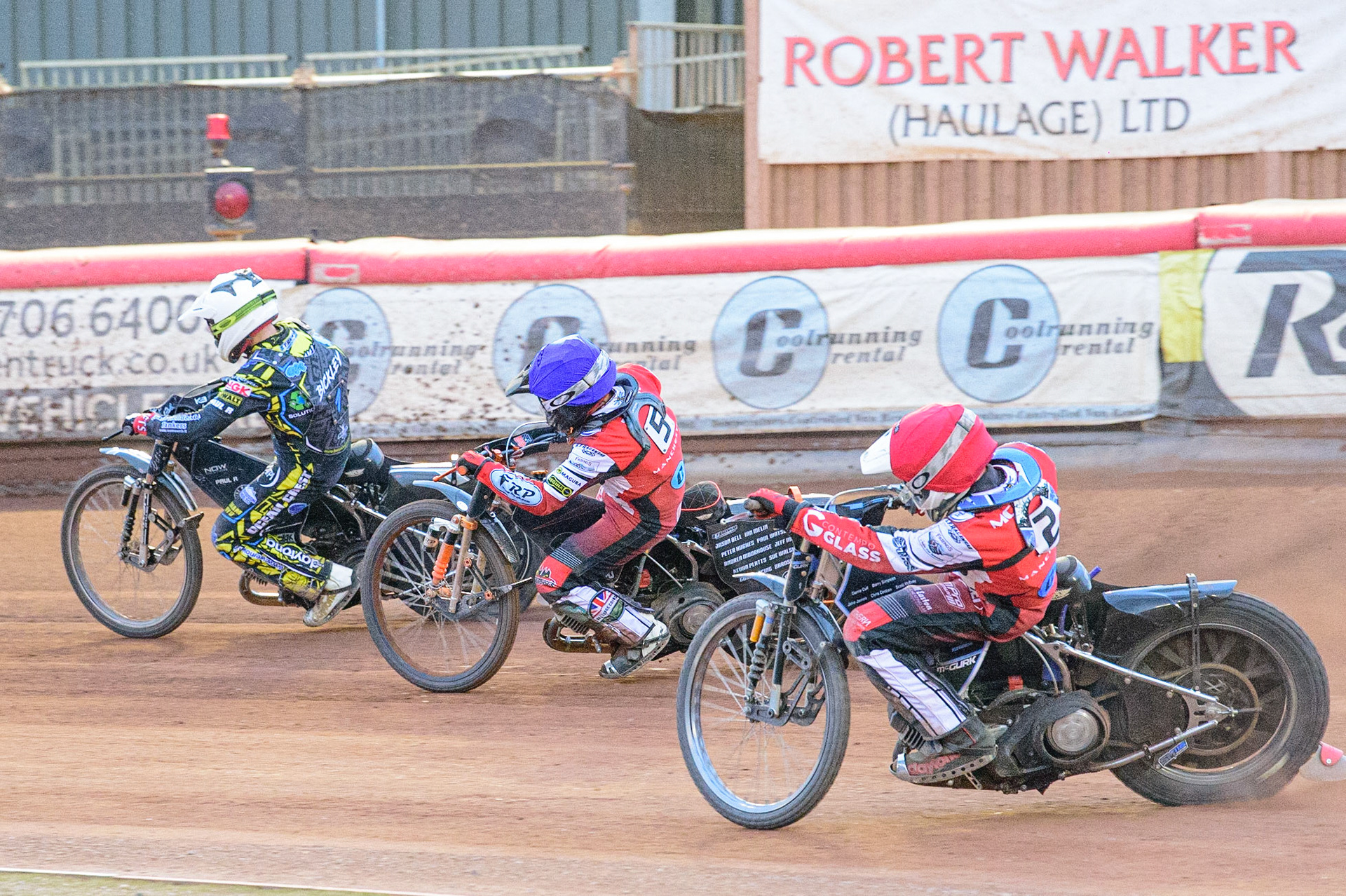 MANCHESTER, UK. JUN 24TH  Sam McGurk  (Red) chases Jack Smith  (Blue) and Kyle Bickley  (White) during the National Development League match between Belle Vue Colts and Berwick Bullets at the National Speedway Stadium, Manchester on Friday 24th June 2022. (Credit: Ian Charles | MI News)