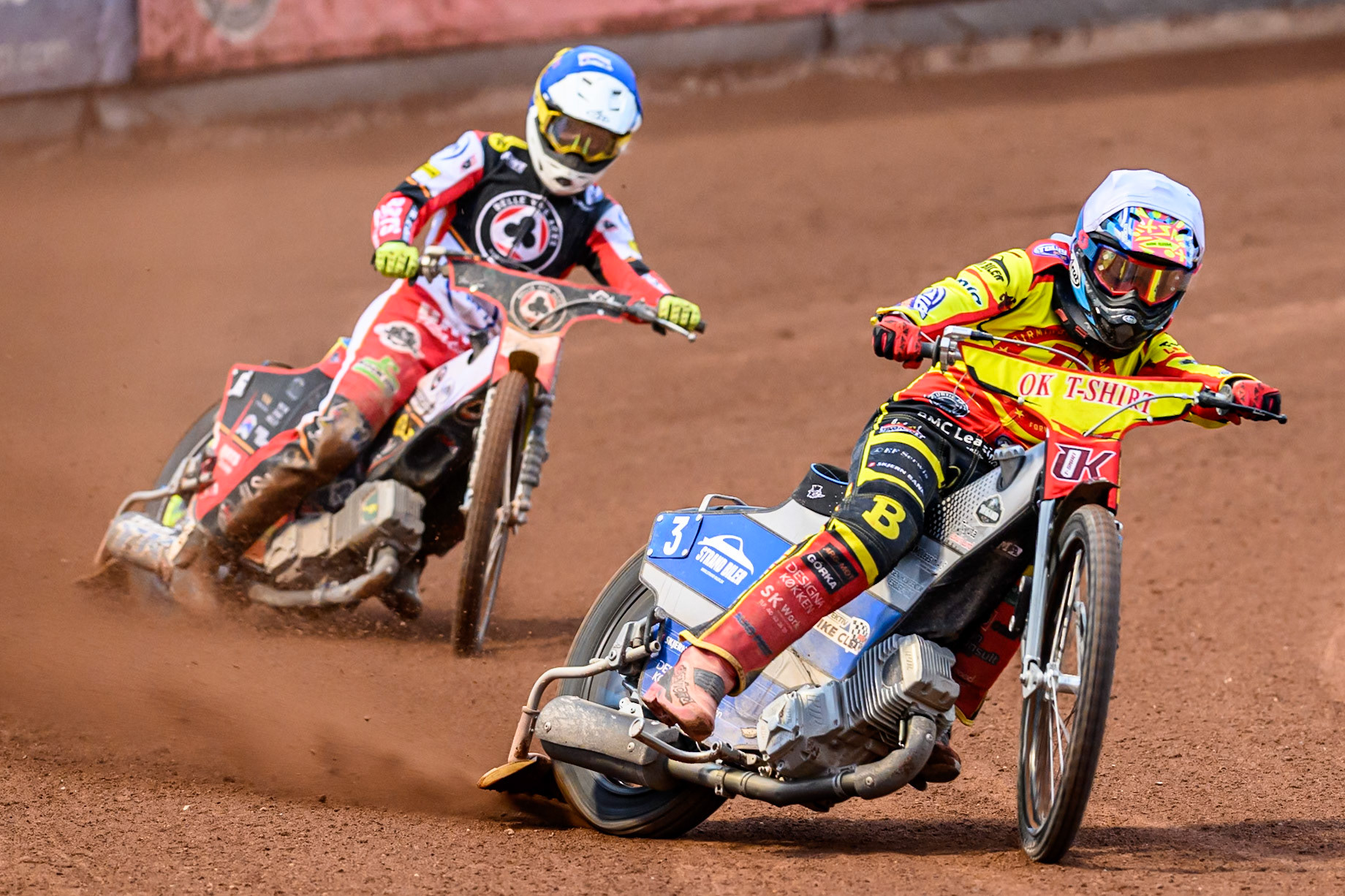Birmingham Brummies' Jonas Jeppesen  in White leading Belle Vue Aces' Tate Zischke in Blue during the Rowe Motor Oil Premiership match between Belle Vue Aces and Birmingham Brummies at the National Speedway Stadium, Manchester on Monday 7th July 2025. (Photo: Ian Charles | MI News)