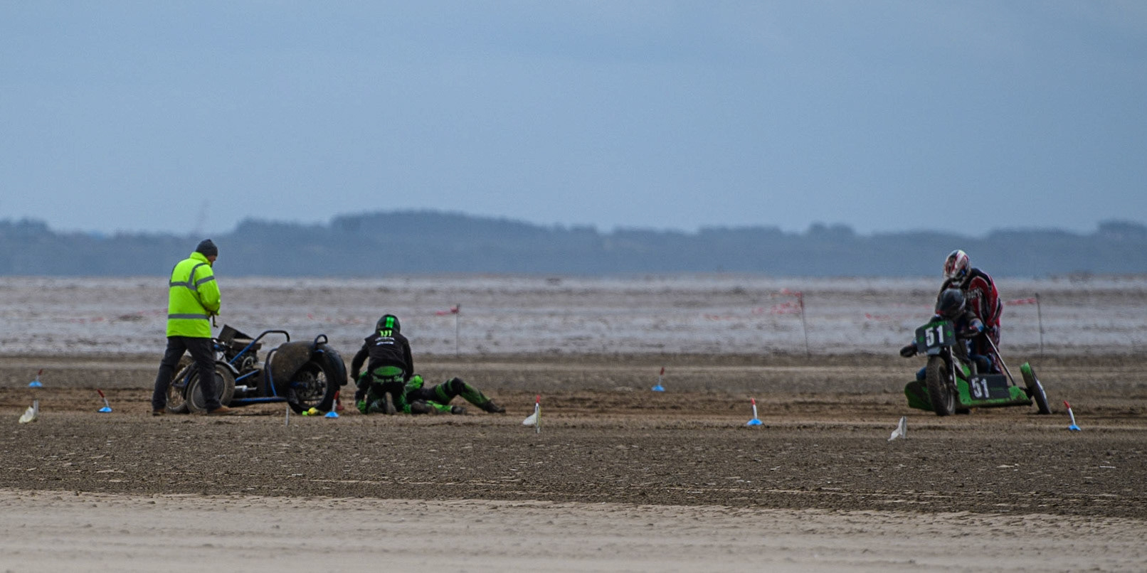 Billy Winterburn &amp; Ryan Wharton (94) after their crash, as Rick McCauley &amp; Stephen Russell (51) ride to the scene during the Fylde ACU British Sand Racing Masters Championship at  St Annes on Sea, Lancashire on Sunday 30th July 2023. (Photo: Ian Charles | MI News)
