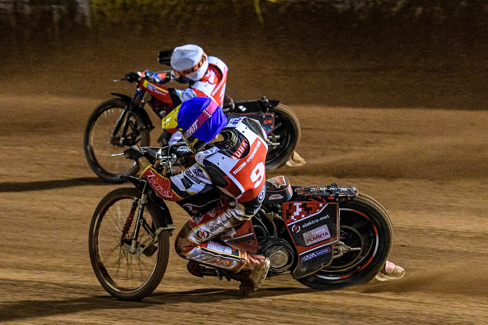 Poland's Patryk Wojdylo (Blue) chases Australia's Ben Cook (White) during the Peter Craven Memorial Trophy meeting at the National Speedway Stadium, Manchester on Monday 18th March 2024. (Photo: Ian Charles | MI News)