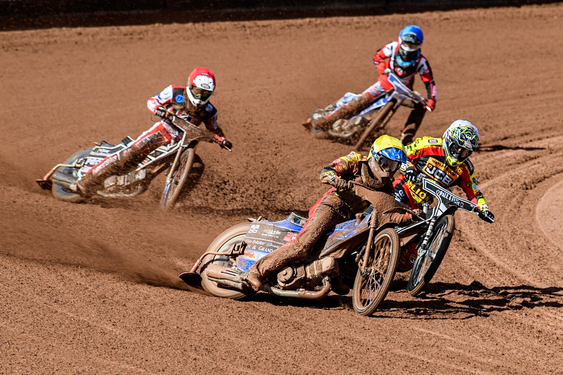 Leicester Lion Cubs' Sonny Springer  (Yellow) outside team mate Leicester Lion Cubs' Luke Crang (White) with Belle Vue Colts' Jack Shimelt (Red) and Belle Vue Colts' Harry McGurk behind during the WSRA  National Development League match between Belle Vue Colts and Leicester Lion Cubs at the National Speedway Stadium, Manchester on Friday 29th March 2024. (Photo: Ian Charles | MI News)