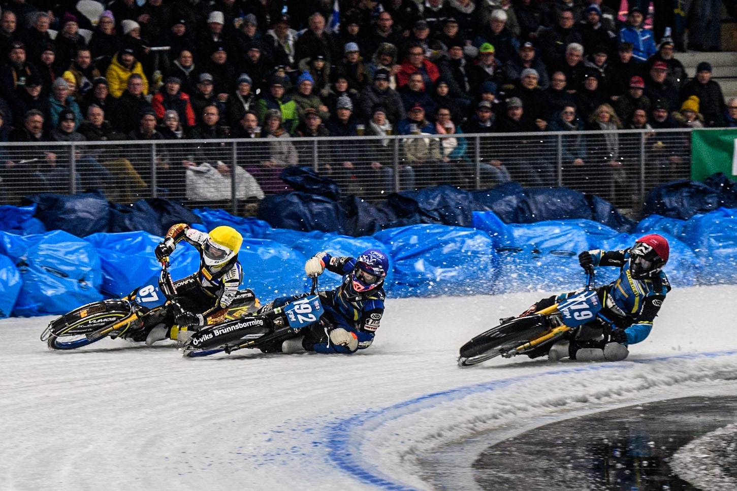 Martin Haarahiltunen (199) of Sweden in Red rides inside Niclas Svensson (192) of Sweden in Blue and Heikki Huusko (67) of Finland in Yellow during the Ice Speedway Gladiators World Championship Final 2 at Max-Aicher-Arena, Inzell on Sunday 16th March 2025. (Photo: Ian Charles | MI News)