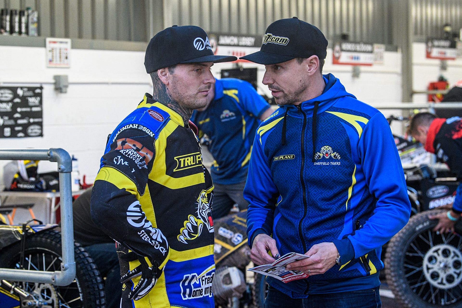 Lewis Kerr  (left) chats with \Sheffield TruPlant Tigers Team manager Simon Stead  during the Sports Insure Premiership match between Belle Vue Aces and Sheffield Tigers at the National Speedway Stadium, Manchester on Monday 7th August 2023. (Photo: Ian Charles | MI News)