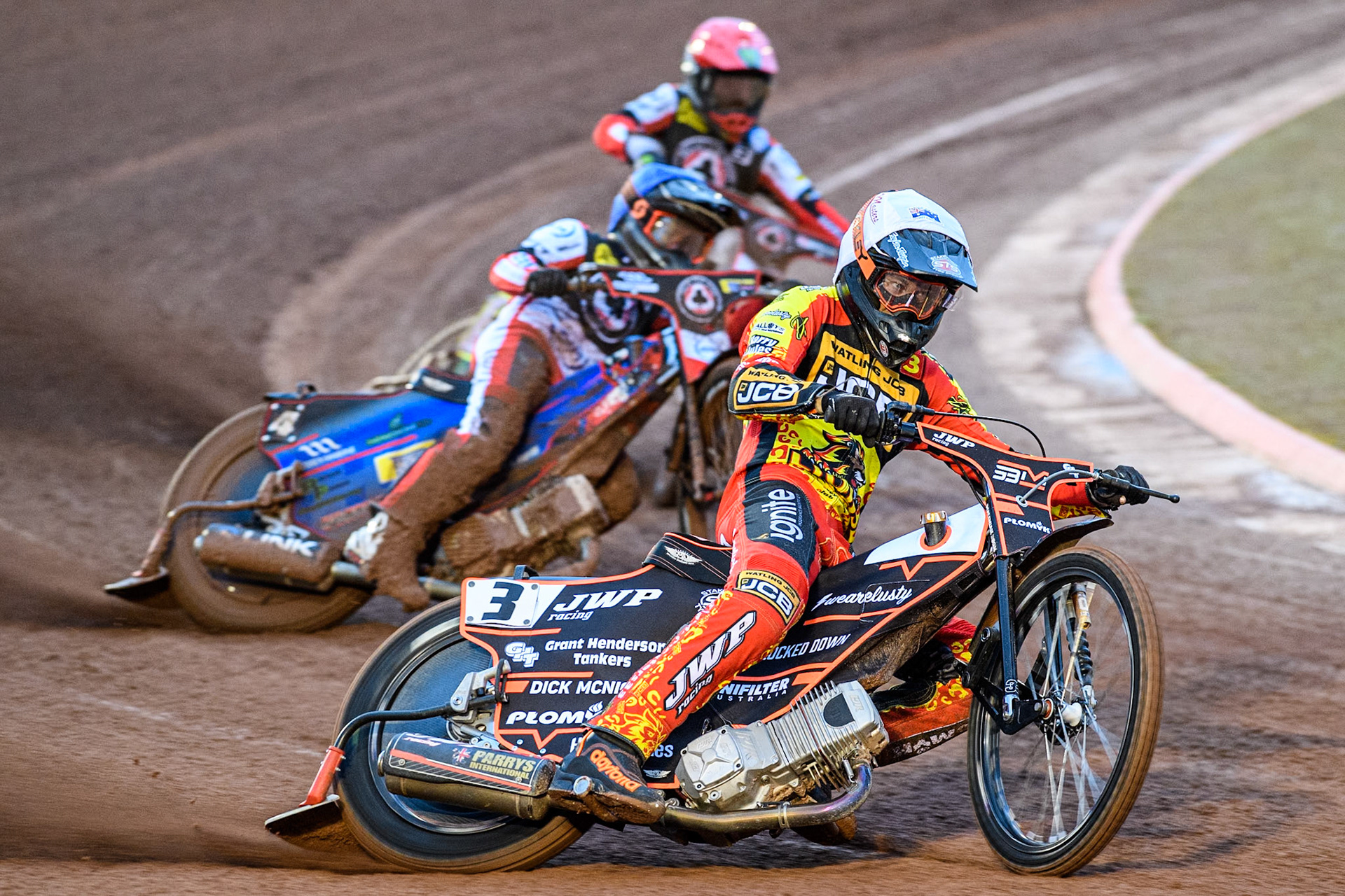 Sam Masters of Leicester Lions in White leading Ben Cook of Belle Vue Aces in Blue and Jaimon Lidsey of Belle Vue Aces in Red during the Rowe Motor Oil Premiership match between Belle Vue Aces and Leicester Lions at the National Speedway Stadium, Manchester on Saturday 6th April 2024. (Photo: Ian Charles | MI News)