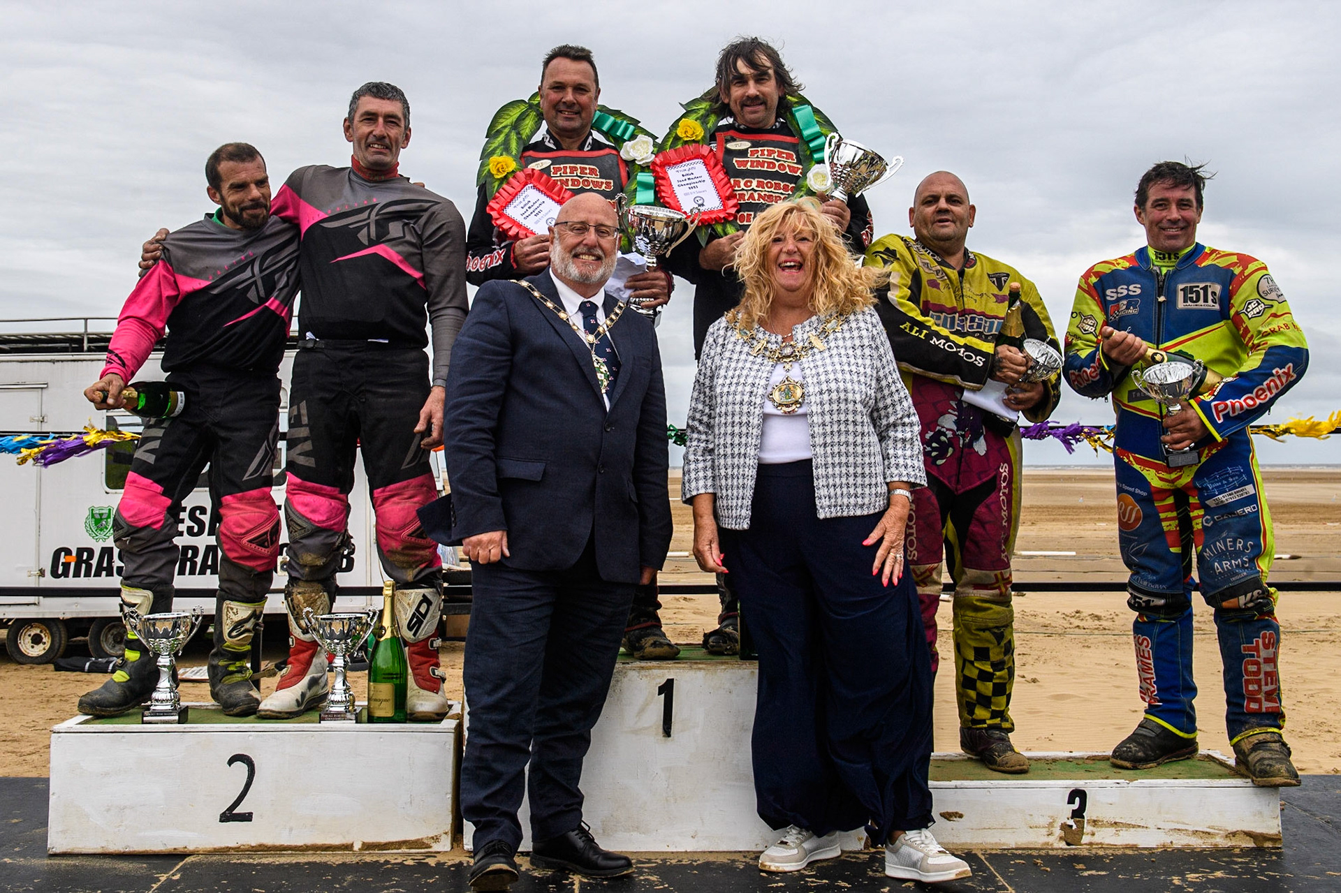Sidecars Top 3: (l - r) Neal Owen &amp; Jason Farwell (12) (2nd), Colin Blackbourn &amp; Carl Pugh (25) (Winners) Clint Blondell &amp; Richard Webb (10) (3rd). Foreground Cllr Cheryl Little, The Worshipful Mayer of Fylde (right) with her Consort during the Fylde ACU British Sand Racing Masters Championship at  St Annes on Sea, Lancashire on Sunday 30th July 2023. (Photo: Ian Charles | MI News)