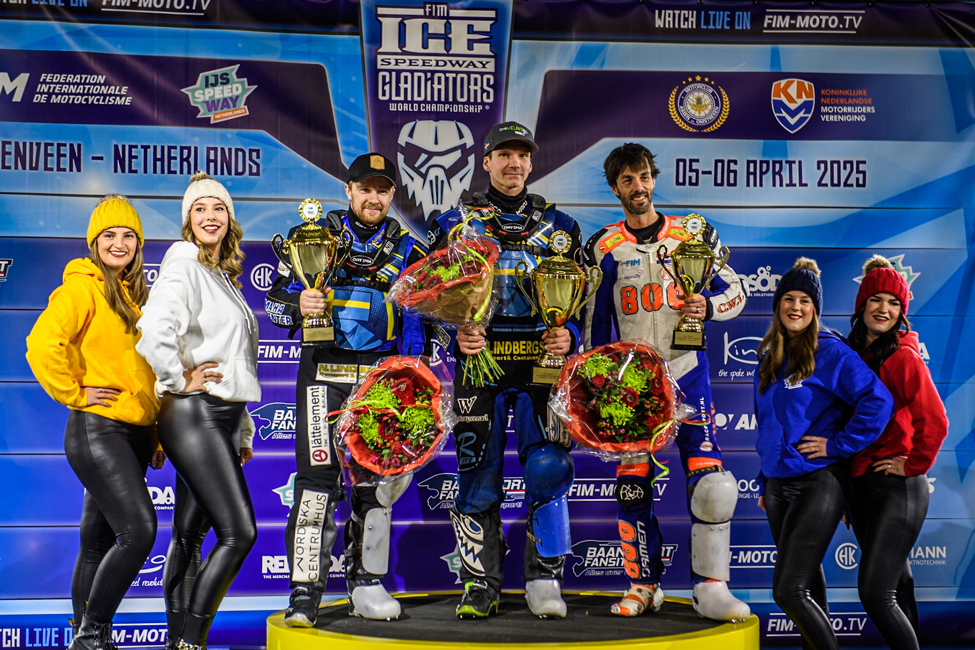 Sundays Top 3: (L to R) Martin Haarahiltunen (2nd), Niclas Svensson (Winner) Jasper Iwema (3rd) with the start line girls during the FIM Ice Speedway Gladiators World Championship, Final 4 at the Ice Stadium, Thialf, Heerenveen on Sunday 6th April 2025. (Photo: Ian Charles | MI News)