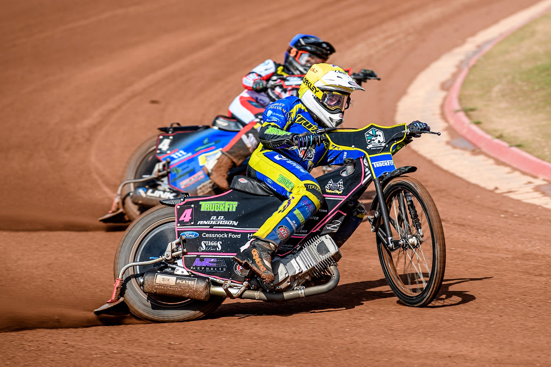 Sheffield Tigers' Josh Pickering  in Yellow leading Belle Vue Aces' Ben Cook  in Blue during the Rowe Motor Oil Premiership match between Belle Vue Aces and Sheffield Tigers at the National Speedway Stadium, Manchester on Monday 26th August 2024. (Photo: Ian Charles | MI News)