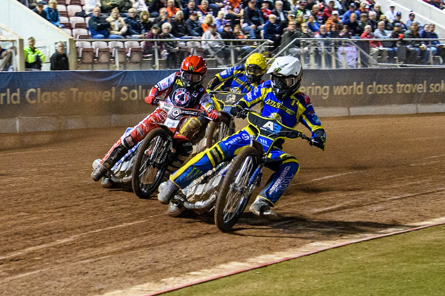 Sheffield Tigers' Jack Holder  in White leading Belle Vue Aces' Dan Bewley  in Red and Sheffield Tigers' Kyle Howarth  in Yellow during the Rowe Motor Oil Premiership Play Off Semi Final 2, 1st Leg match between Belle Vue Aces and Sheffield Tigers at the National Speedway Stadium, Manchester on Monday 16th September 2024. (Photo: Ian Charles | MI News)