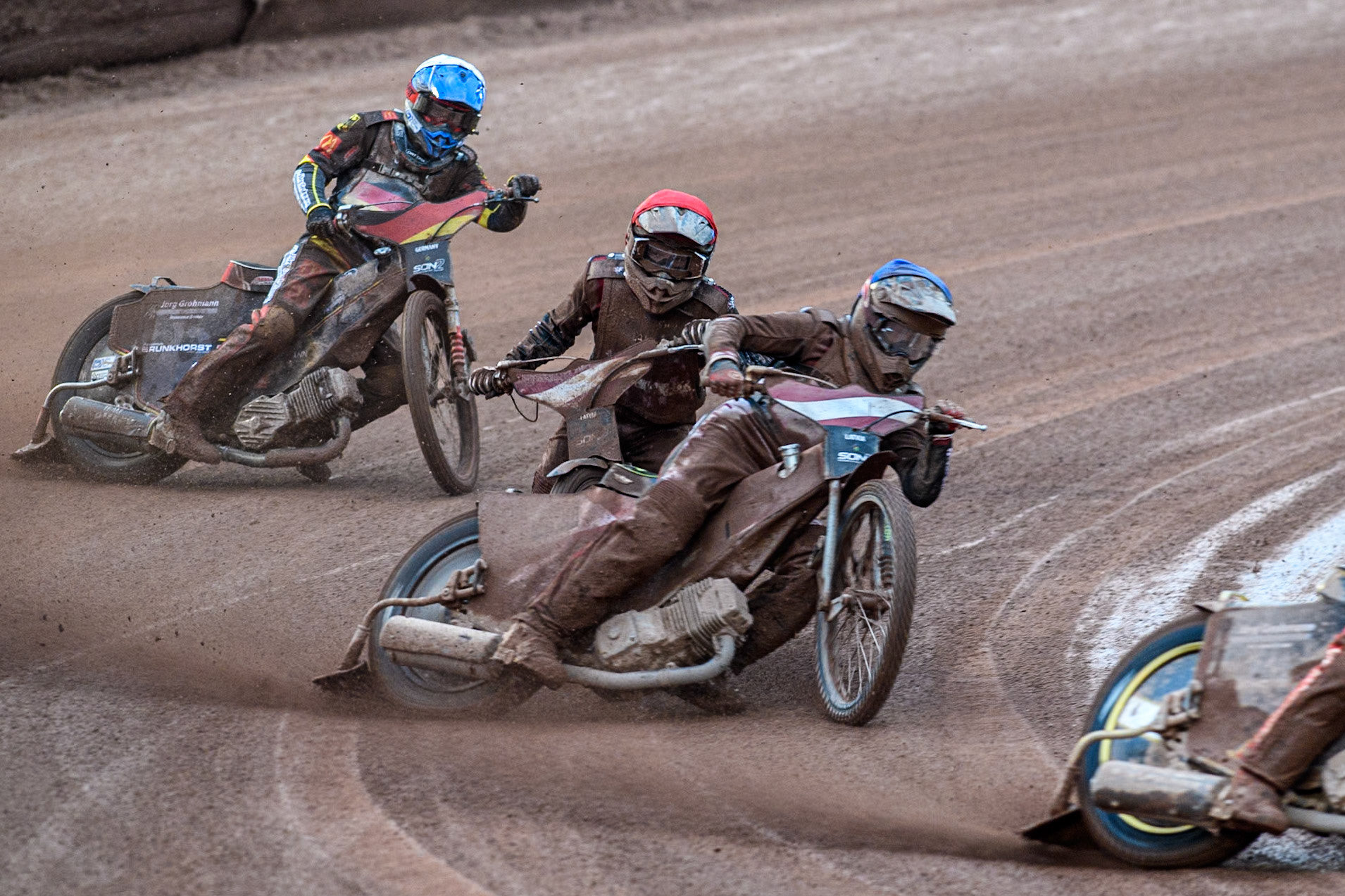 Norick Blödorn of Germany in Yellow leading Nikita Kaulins of Latvia in Blue as Artjoms Juhno of Latvia in Red picks up some drive ahead of Patrick Hyjek of Germany in White during the Monster Energy FIM Speedway of Nations 2 (Under 21) Final at the National Speedway Stadium, Manchester on Friday 12th July 2024. (Photo: Ian Charles | MI News)