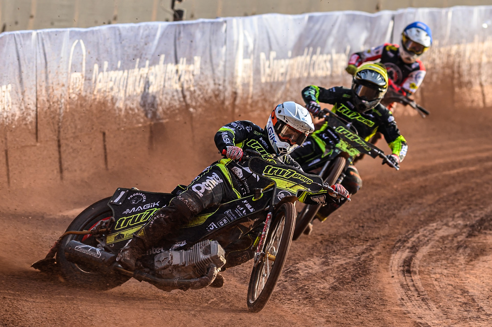 Ipswich Witches' Emil Saifutdinov  in White leading Ipswich Witches' Danny King in Yellow and Belle Vue Aces' Zach Cook  in Blue during the Rowe Motor Oil Premiership match between Belle Vue Aces and Ipswich Witches at the National Speedway Stadium, Manchester on Monday 30th June 2025. (Photo: Ian Charles | MI News)