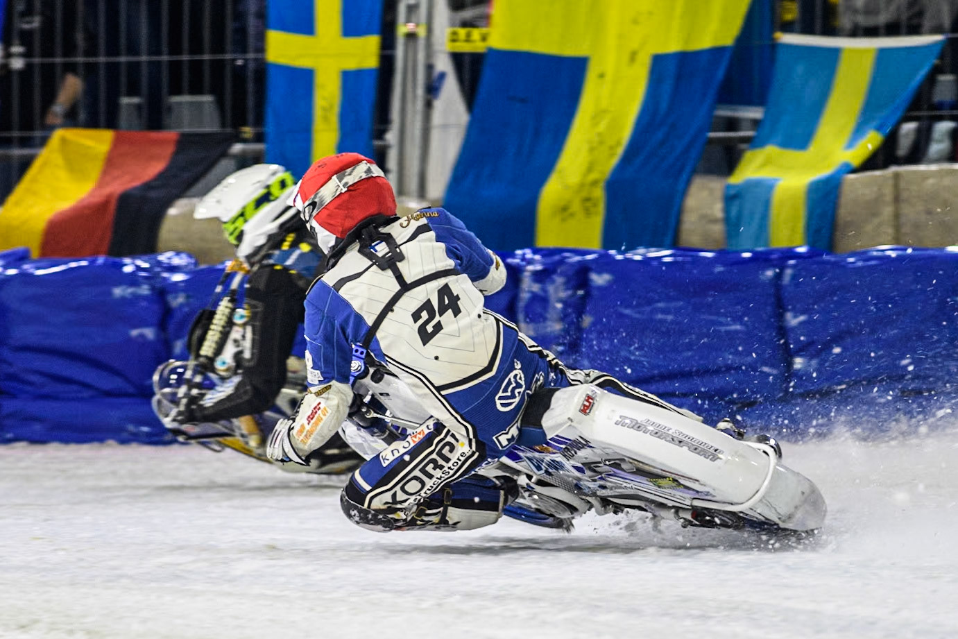 Finland's Max Koivula (24) in Red chases Sweden"s Jimmy Olsén (81) in White during the FIM Ice Speedway Gladiators World Championship Final 3 at Ice Rink Thialf, Heerenveen on Saturday 6th April 2024. (Photo: Ian Charles | MI News)