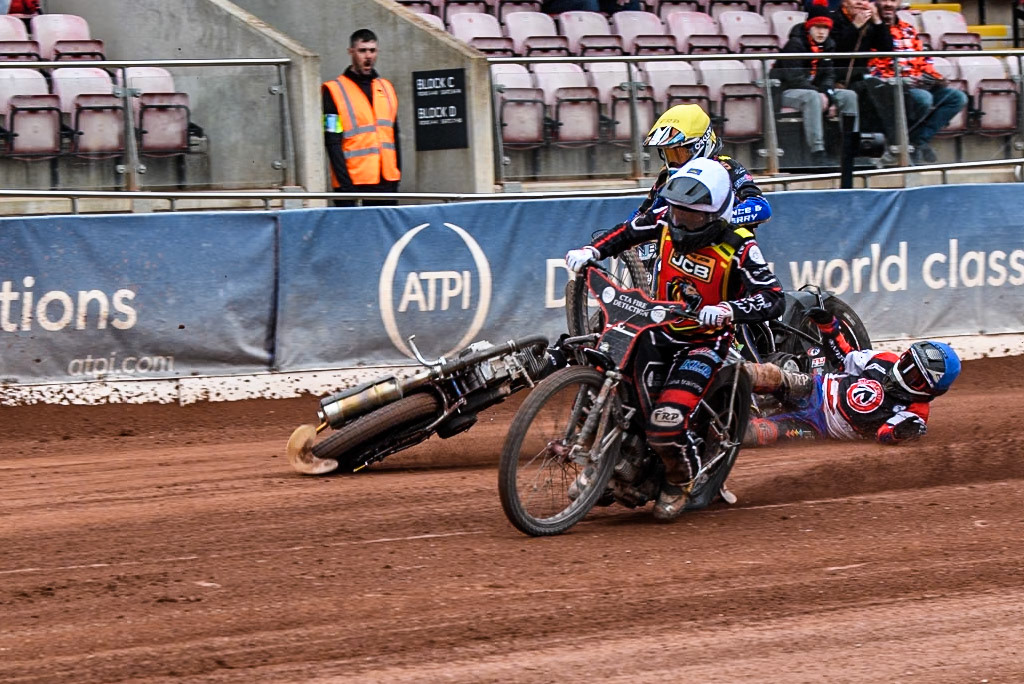 Belle Vue Colts' Harry Fletcher in Blue rears and falls between Leicester Lion Cubs' Guest Rider Ben Morley in White and Leicester Lion Cubs' Eli Meadows in Yellow during the WSRA National Development League match between Belle Vue Colts and Leicester Lion Cubs at the National Speedway Stadium, Manchester on Friday 18th April 2025. (Photo: Ian Charles | MI News)