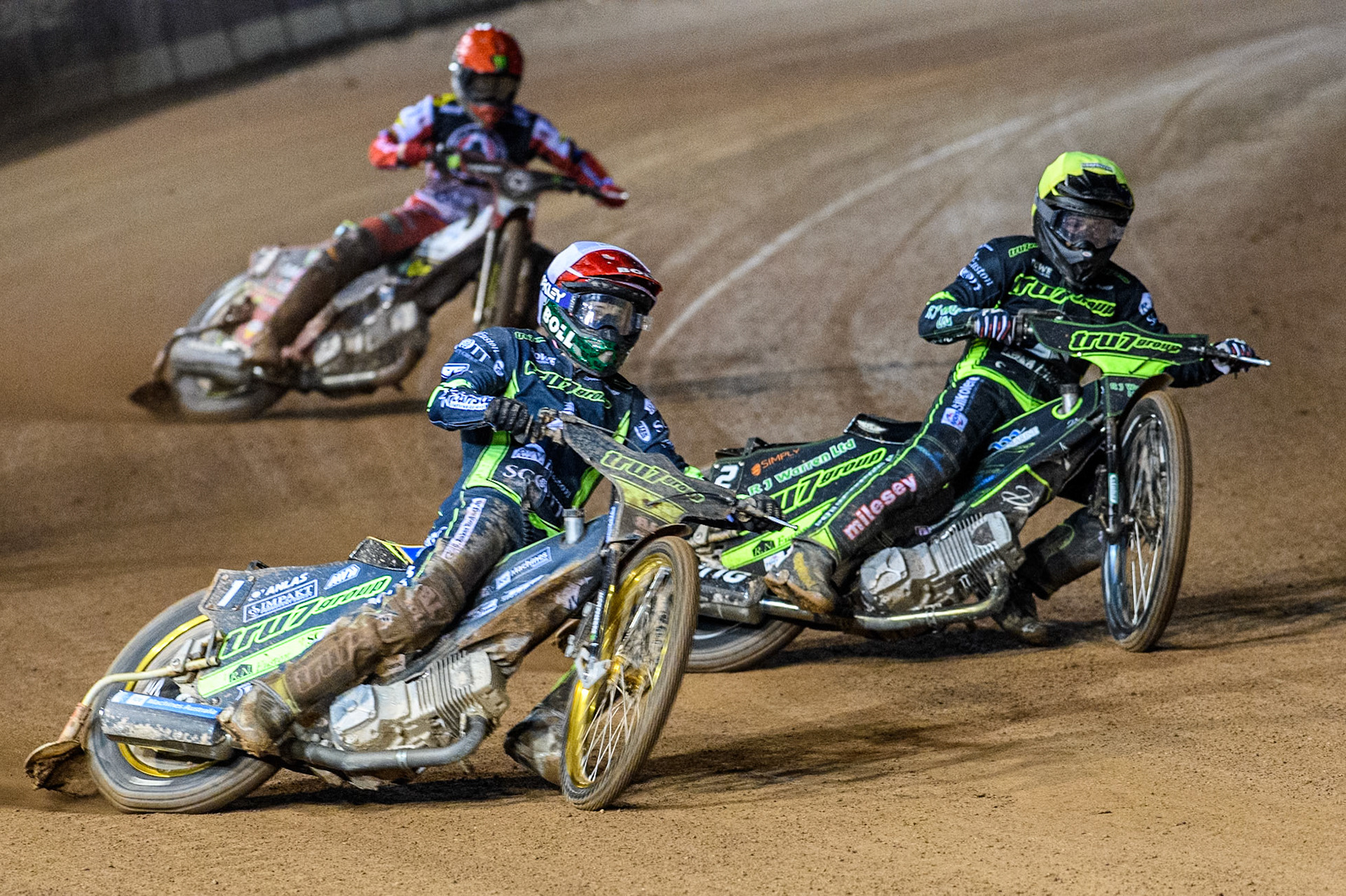 Jason Doyle of Ipswich Witches in White rides outside team mate Danny King with Jaimon Lidsey of Belle Vue Aces in Red behind during the Premiership Cup Quarter Final 1st Leg match between Belle Vue Aces and Ipswich Witches at the National Speedway Stadium, Manchester on Monday 24th March 2025. (Photo: Ian Charles | MI News)