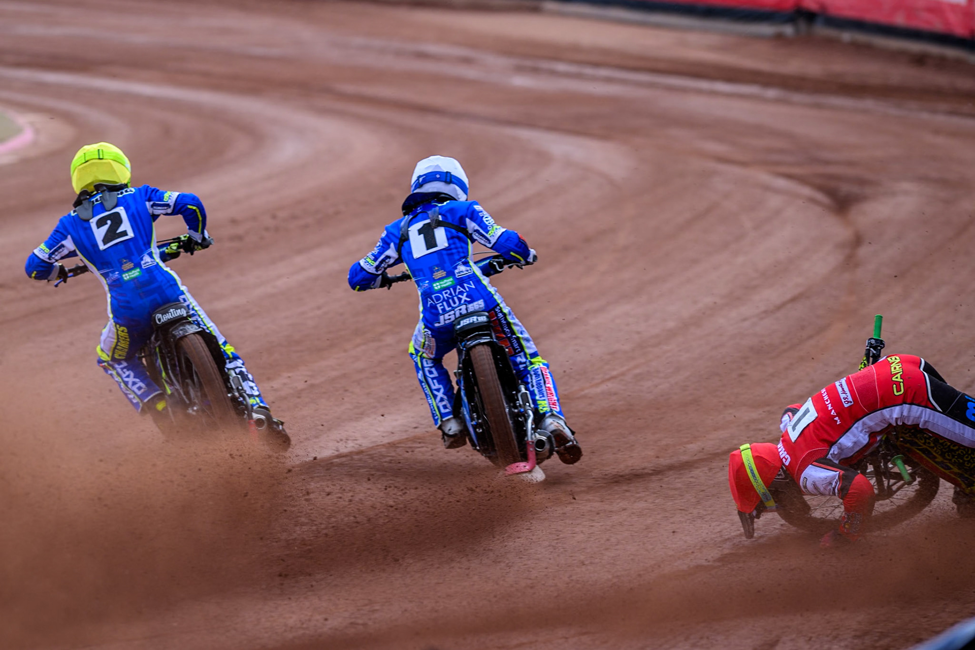 Belle Vue Colts' William Cairns falls whilst trying to pass Oxford Chargers' Jody Scott  in White and Oxford Chargers' Jacob Clouting  in Yellow during the WSRA National Development League match between Belle Vue Colts and Oxford Chargers at the National Speedway Stadium, Manchester on Sunday 1st June 2025. (Photo: Ian Charles | MI News)