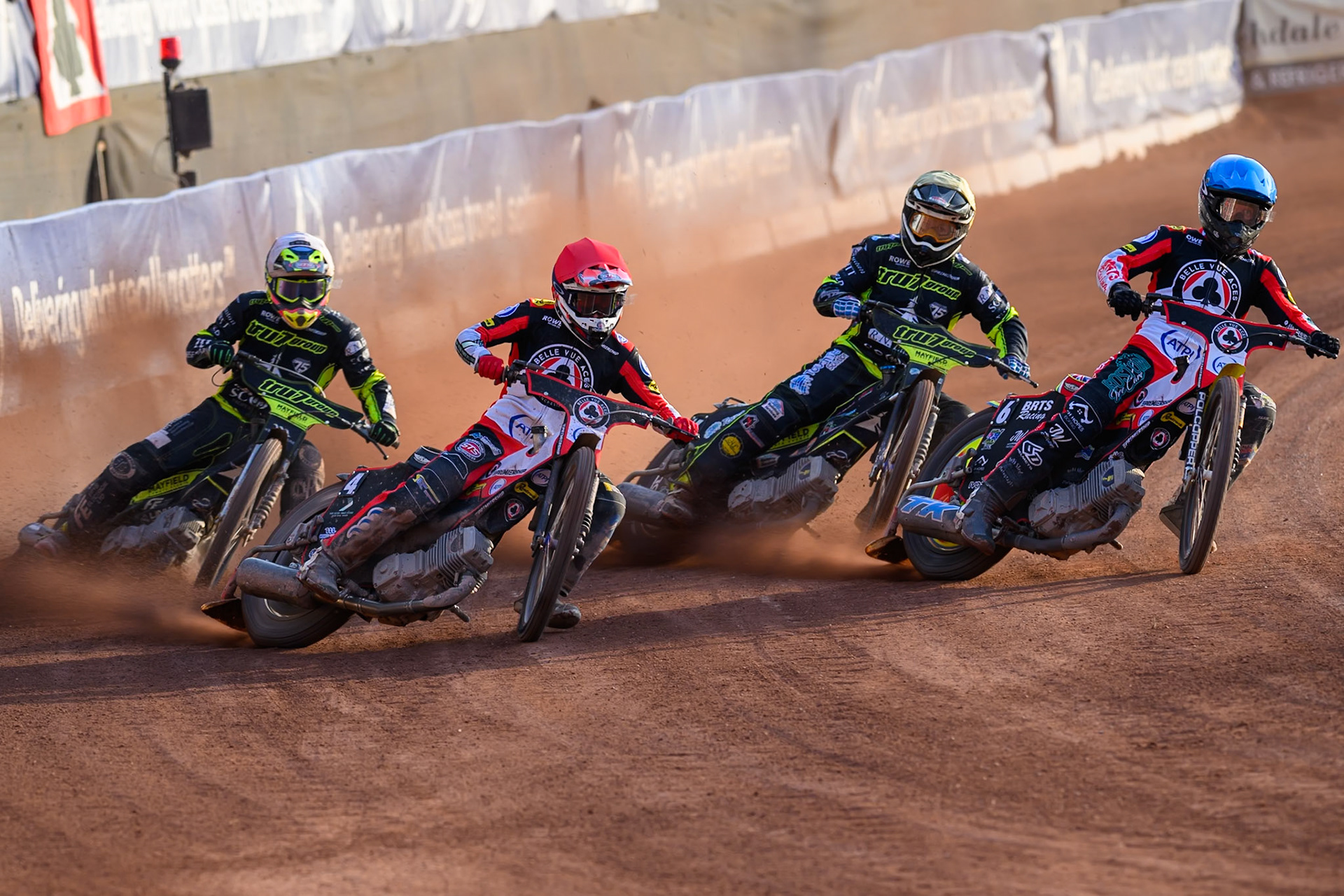 Zach Cook of Belle Vue Aces in Red and Tate Zischke of Belle Vue Aces in Blue leading Richard Lawson of Ipswich Witches in White and Scott Nichols of Ipswich Witches in Yellow during the Rowe Motor Oil Premiership match between Belle Vue Aces and Ipswich Witches at the National Speedway Stadium, Manchester on Saturday 20th June 2026. (Photo: Ian Charles | MI News)