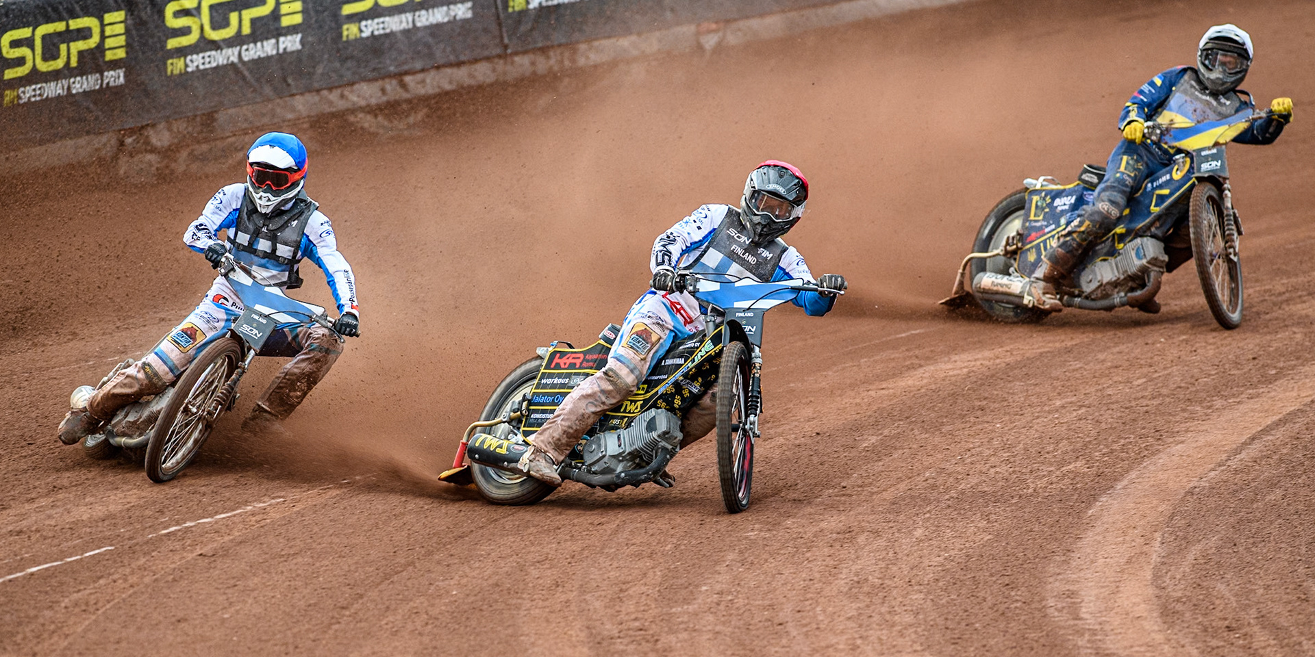 Finland v Ukraine: Jesse Mustonen of Finland in Red and Antti Vuolas of Finland in Blue leading Stanislav Melnychuk of Ukraine in White during the Monster Energy FIM Speedway of Nations Semi-Final 1 at the National Speedway Stadium, Manchester on Tuesday 9th July 2024. (Photo: Ian Charles | MI News)