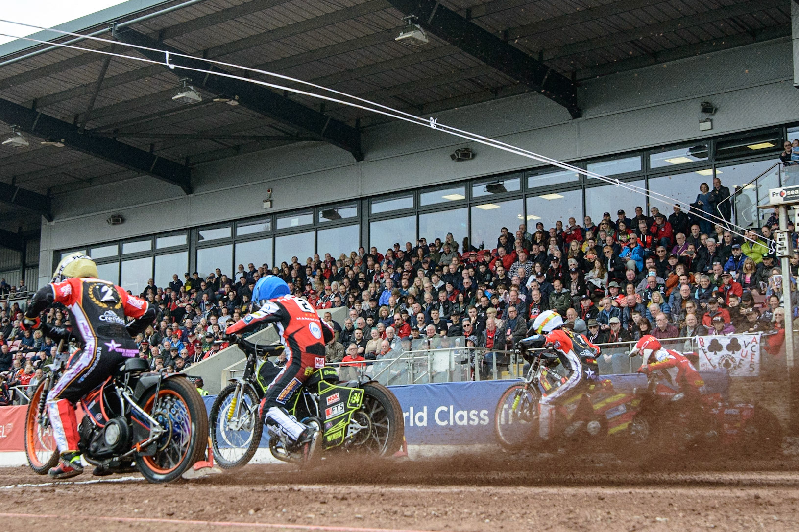 MANCHESTER, UK. MAY 2ND  (l-2) Scott Nicholls  (Yellow), Jye Etheridge   (Blue), Michael Palm Toft  (White) and Max Fricke (Red) leave the start during the SGB Premiership match between Belle Vue Aces and Peterborough at the National Speedway Stadium, Manchester on Monday 2nd May 2022. (Credit: Ian Charles | MI News)