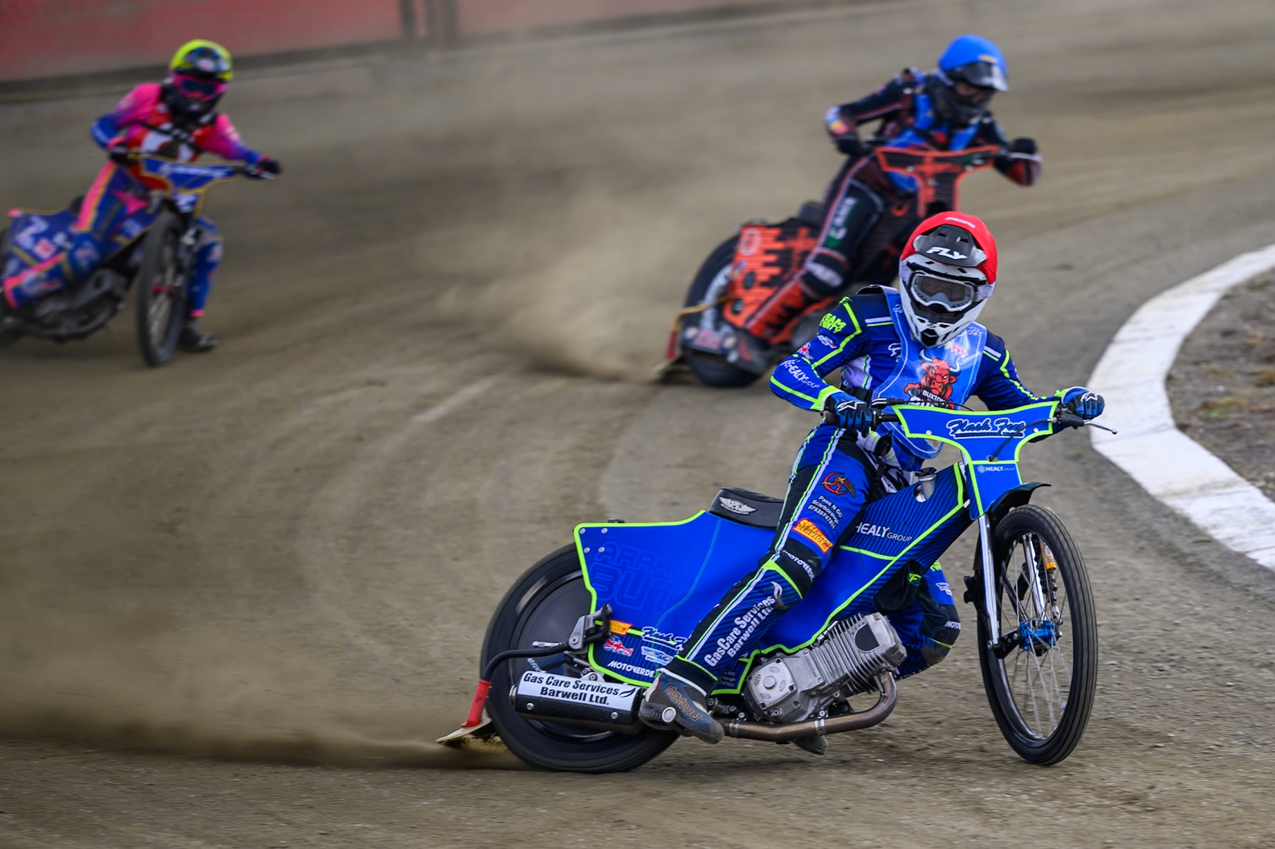 Arran Butcher of Buxton Bulls  in Red leading Bailey Fellows of Buxton Bulls  in Blue and Owen Booth of NDL Nomads   in Yellow during the  Challenge match between Buxton Bulls and NDL Nomads at Hi-Edge Speedway, Buxton on Sunday 19th April 2026. (Photo: Ian Charles | MI News)