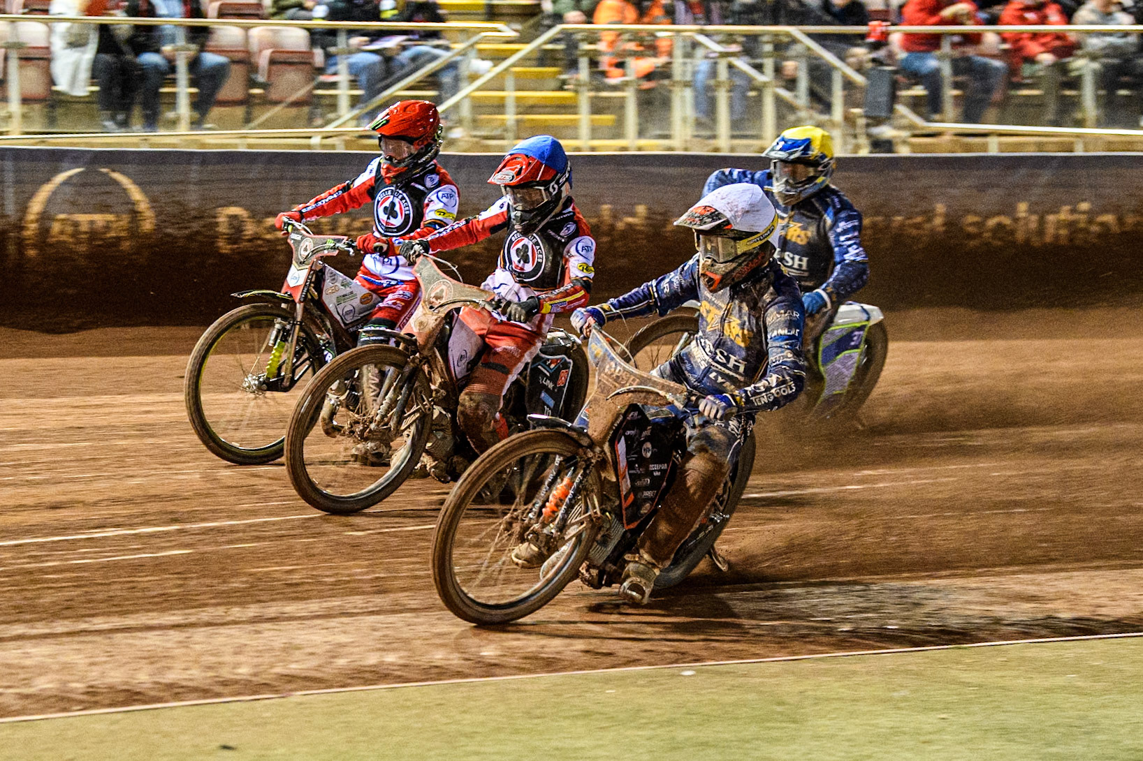 Niels-Kristian Iversen of Kings Lynn Stars in White rides inside Zach Cook of Belle Vue Aces in Blue and Jaimon Lidsey of Belle Vue Aces in Red with Chris Harris of Kings Lynn Stars behind during the Rowe Motor Oil Premiership match between Belle Vue Aces and King's Lynn Stars at the National Speedway Stadium, Manchester on Monday 5th April 2025. (Photo: Ian Charles | MI News)