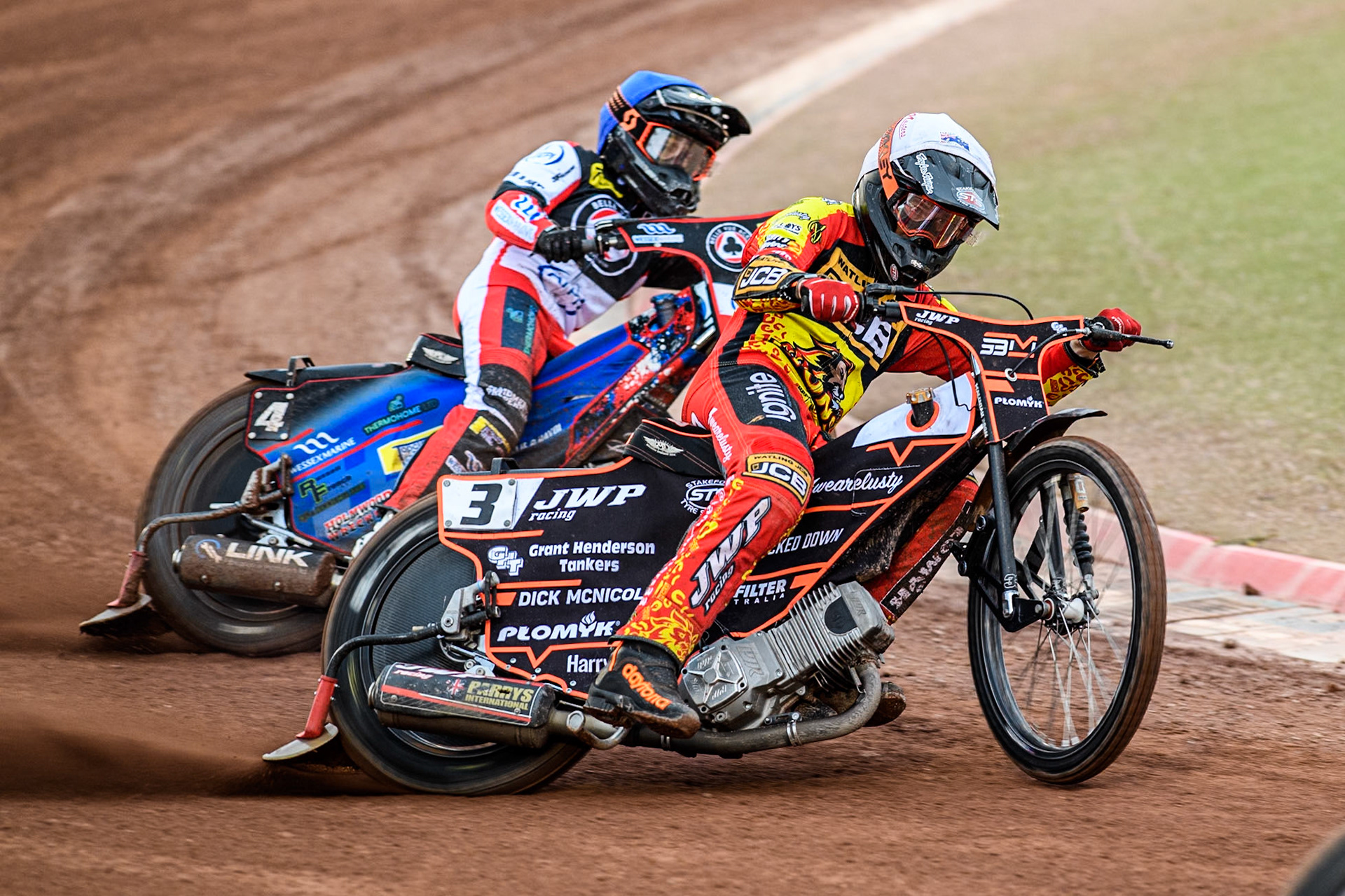 Leicester Lions' Sam Masters in White leading Belle Vue Aces' Ben Cook in Blue during the Rowe Motor Oil Premiership match between Belle Vue Aces and Leicester Lions at the National Speedway Stadium, Manchester on Monday 24th June 2024. (Photo: Ian Charles | MI News)