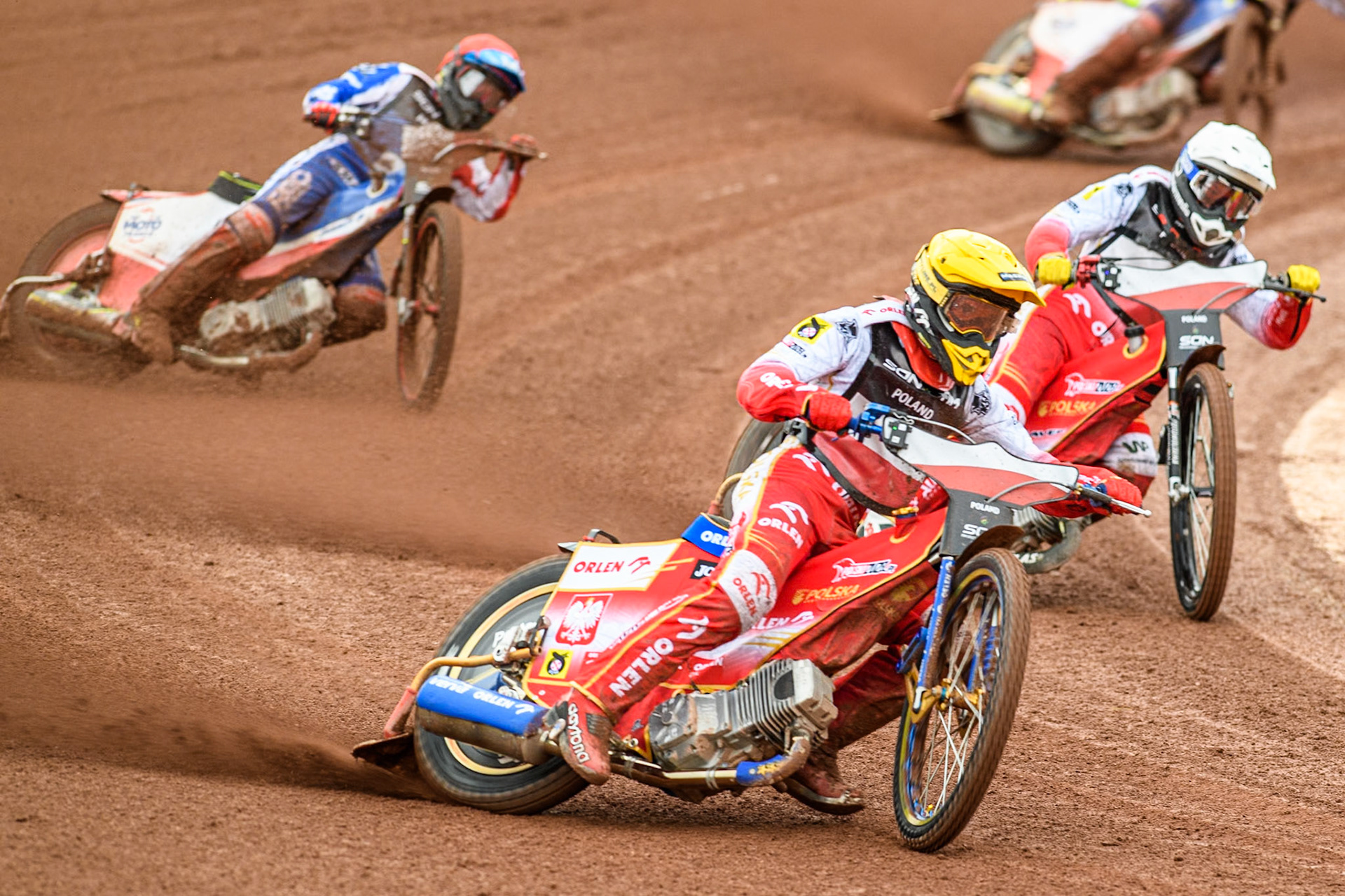 Bartosz Zmarzlik of Poland in Yellow rides outside team mate Dominik Kubera of Poland in White with David Bellego of France in Red behind during the Monster Energy FIM Speedway of Nations Semi-Final 1 at the National Speedway Stadium, Manchester on Tuesday 9th July 2024. (Photo: Ian Charles | MI News)