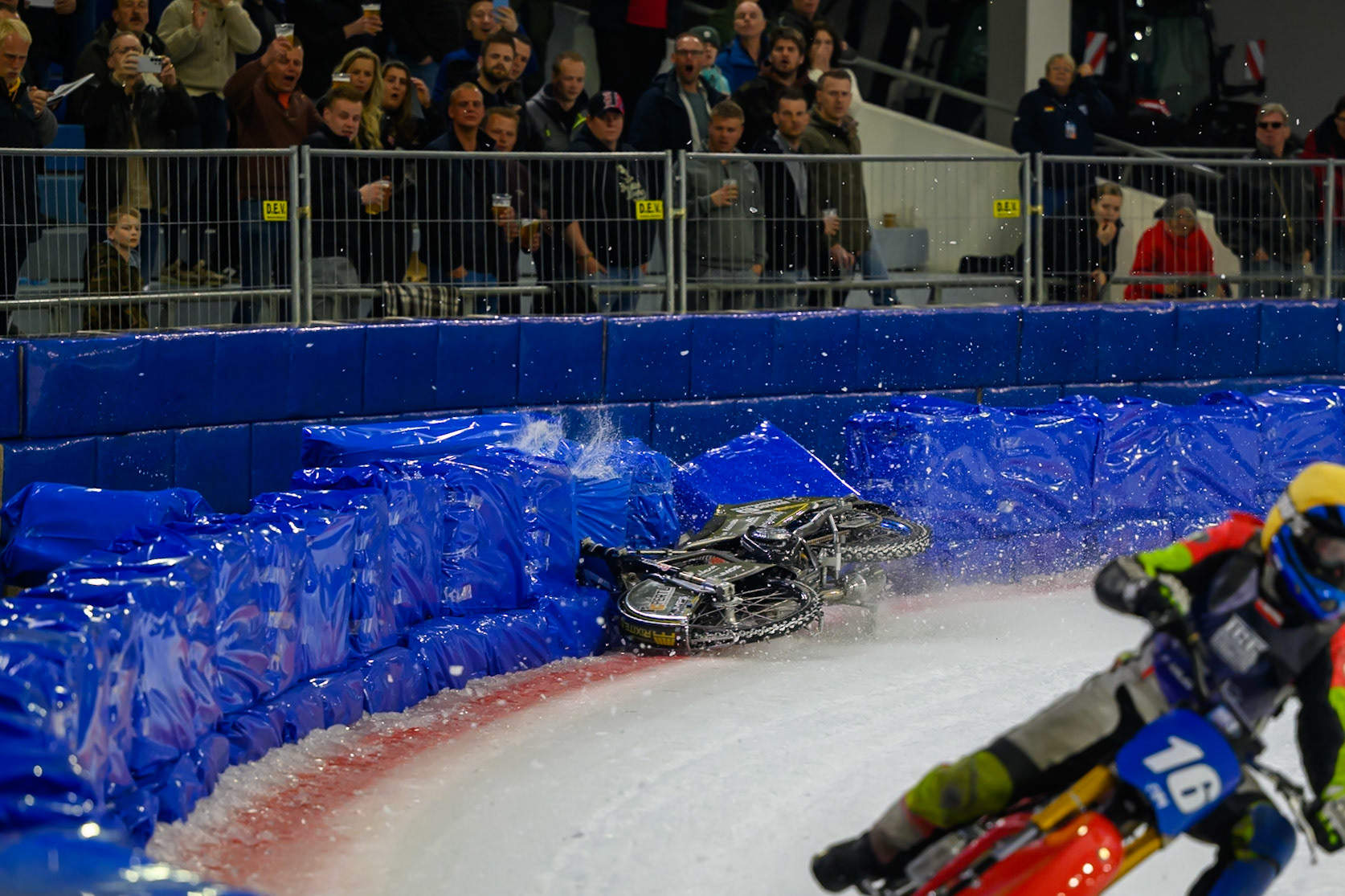 Heikki Huusko (67) of Finland  collides with Wild Card Harald Simon (16) of Austria in Yellow in the first turn during the FIM Ice Speedway Gladiators World Championship Final 3 at Ice Rink Thialf, Heerenveen on Saturday 11th April 2026. (Photo: Ian Charles | MI News)