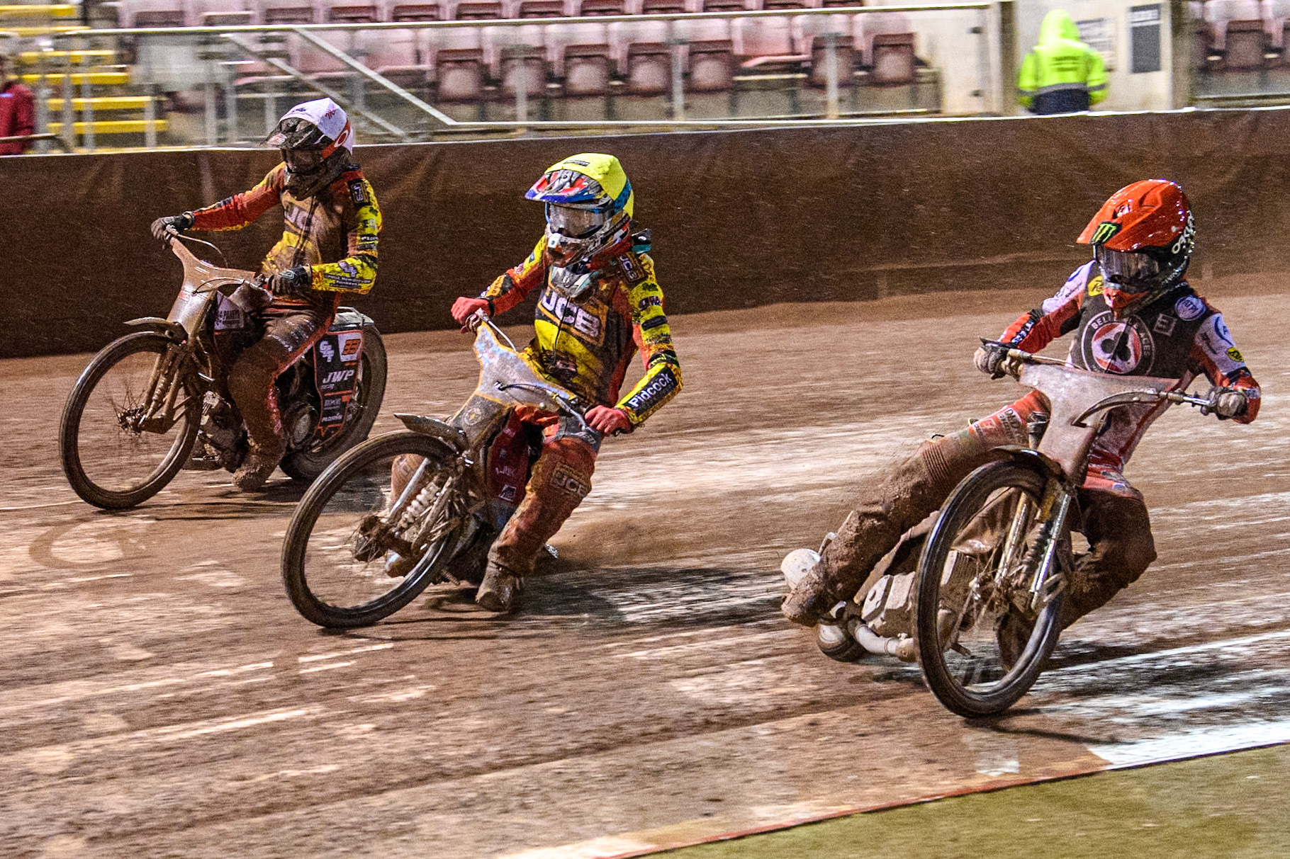 Jaimon Lidsey of Belle Vue Aces in Red rides inside Drew Kemp of Leicester Lions in Yellow and Sam Masters of Leicester Lions in White during the Rowe Motor Oil Premiership match between Belle Vue Aces and Leicester Lions at the National Speedway Stadium, Manchester on Saturday 6th April 2024. (Photo: Ian Charles | MI News)