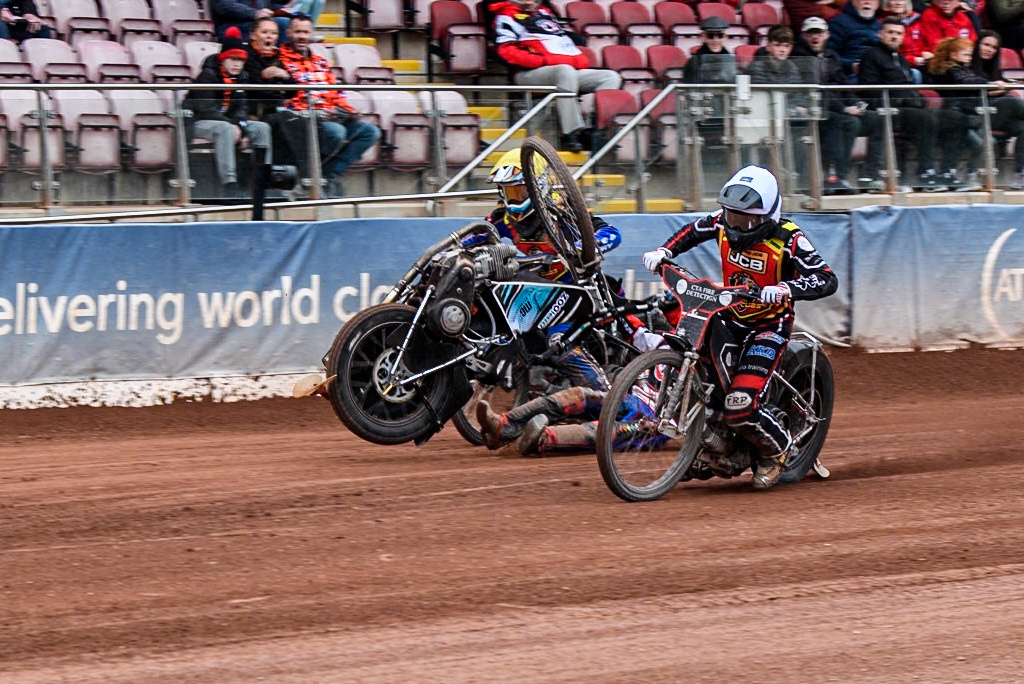 Belle Vue Colts' Harry Fletcher in Blue rears and falls between Leicester Lion Cubs' Guest Rider Ben Morley in White and Leicester Lion Cubs' Eli Meadows in Yellow during the WSRA National Development League match between Belle Vue Colts and Leicester Lion Cubs at the National Speedway Stadium, Manchester on Friday 18th April 2025. (Photo: Ian Charles | MI News)
