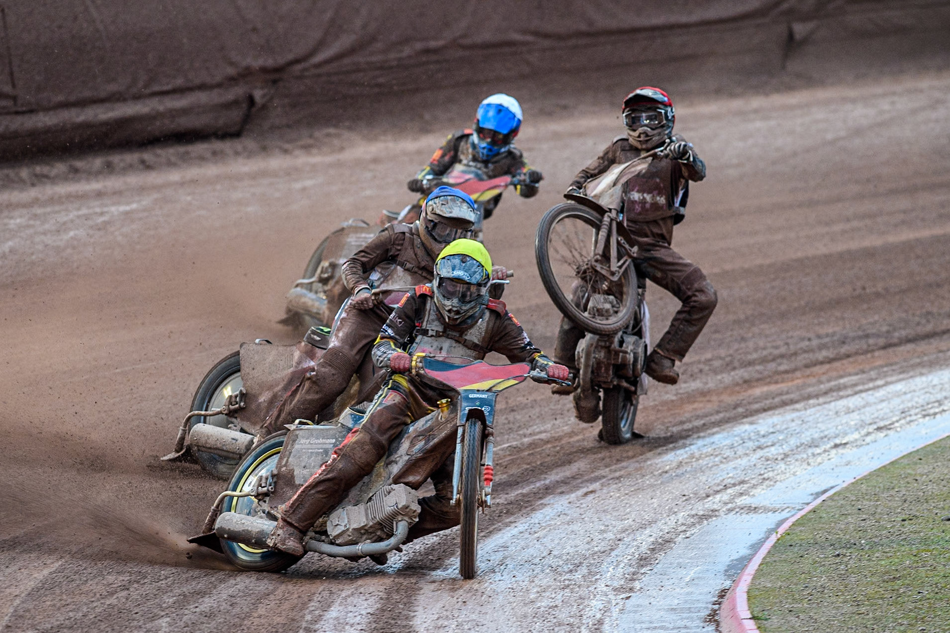 Norick Blödorn of Germany in Yellow leading Nikita Kaulins of Latvia in Blue as Artjoms Juhno of Latvia in Red picks up some drive ahead of Patrick Hyjek of Germany in White during the Monster Energy FIM Speedway of Nations 2 (Under 21) Final at the National Speedway Stadium, Manchester on Friday 12th July 2024. (Photo: Ian Charles | MI News)