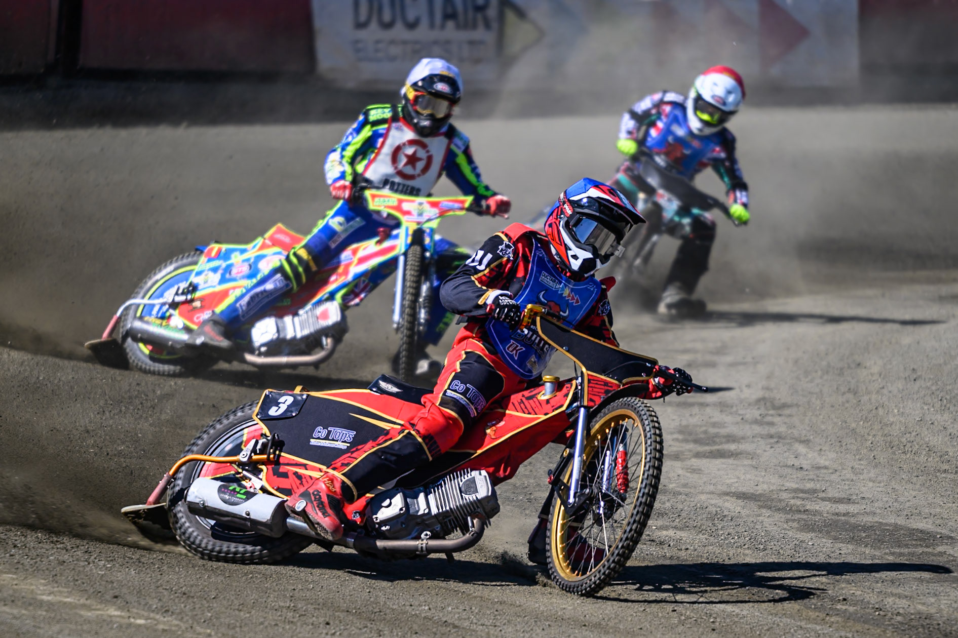 Luke Harris of Buxton Bulls in Blue leading Simon Lambert of Stoke Potters in White and Alfie Bowtell of Buxton Bulls in Red during the National Development League Challenge match between Buxton Bulls and Stoke Potters at Hi-Edge Speedway, Buxton on Sunday 24th May 2026. (Photo: Ian Charles | MI News)