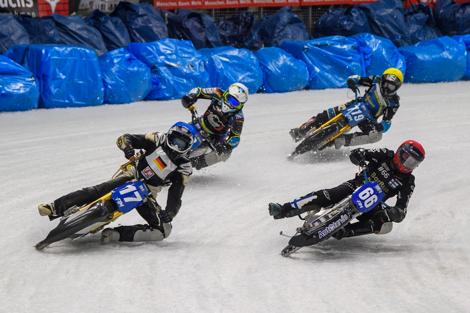 Reserve Franz Mayerbüchler (17) of Germany in Blue rides outside Aki Ala-Riihimäki (66) of Finland in Red with Maximilian Niedermaier (38) of Germany in White and Filip Jäger (719) of Sweden in Yellow behind during the Ice Speedway Gladiators World Championship Final 2 at Max-Aicher-Arena, Inzell on Sunday 16th March 2025. (Photo: Ian Charles | MI News)