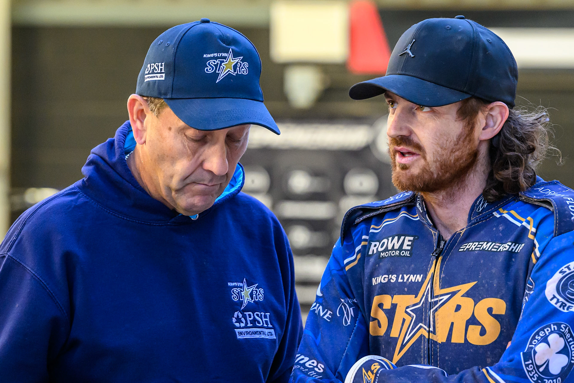 Kings Lynn Stars' Richard Lawson (Right) chats with Kings Lynn Stars' Team Manager Rob Lyon during the Rowe Motor Oil Premiership match between Belle Vue Aces and King's Lynn Stars at the National Speedway Stadium, Manchester on Monday 23rd June 2025. (Photo: Ian Charles | MI News)